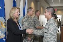 Secretary of the Air Force Deborah Lee James, Air Force Chief of Staff General Mark A. Welsh III and Chief Master Sergeant of the Air Force James A. Cody congratulate Airmen who will soon complete Airmen’s Week Aug. 27, 2015, at Joint Base San Antonio-Lackland’s Pfingston Reception Center. The Airmen received a copy of "America's Air Force: A Profession of Arms," the next evolution of the "Little Blue Book" previously released in 1997. The new book gives Airmen instant access to the core values, codes and creeds that guide Airmen as they serve in the Profession of Arms. The book will be distributed to all new Airmen before transitioning to technical training and available online through Air Force e-publishing. (U.S. Air Force photo by Johnny Saldivar/Released)  