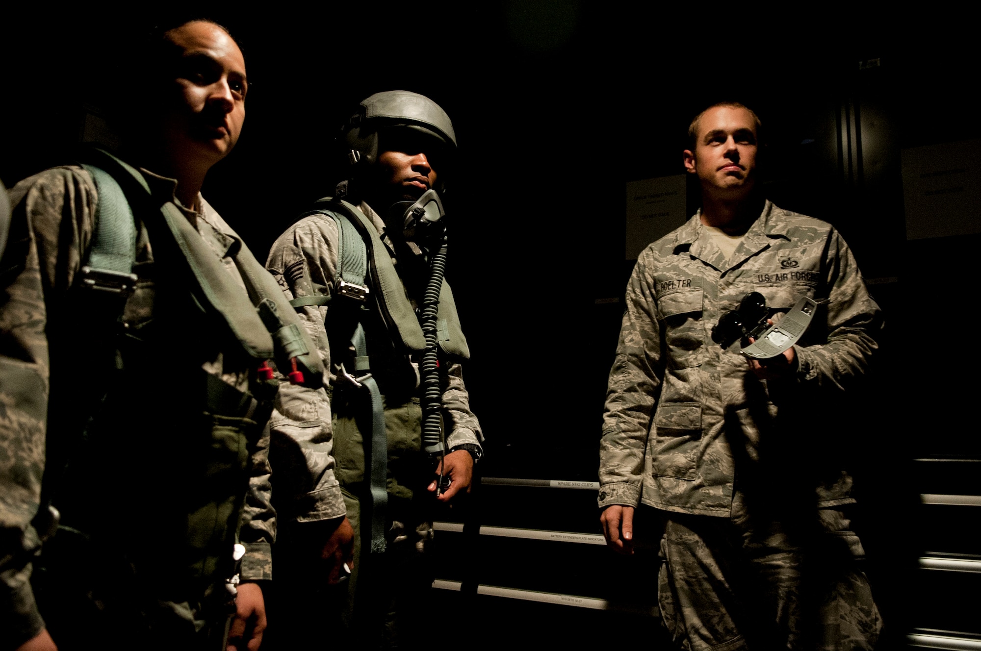 Staff Sgt. Dain Boelter (right), 4th Operations Squadron life support technician, assists  Senior Airmen Andrea Spanjer and Oshane Wint, 4th Medical Group bioenvironmental engineers, experience life support equipment and gear that F-15E Strike Eagle pilots wear during flight, 26 Aug 2015, at Seymour Johnson Air Force Base, North Carolina.  An impromptu tour was provided to these Airmen who support the greater Air Force mission but rarely get to see it up close. (U.S. Air Force photo/Master Sgt. Jocelyn L. Rich-Pendracki)