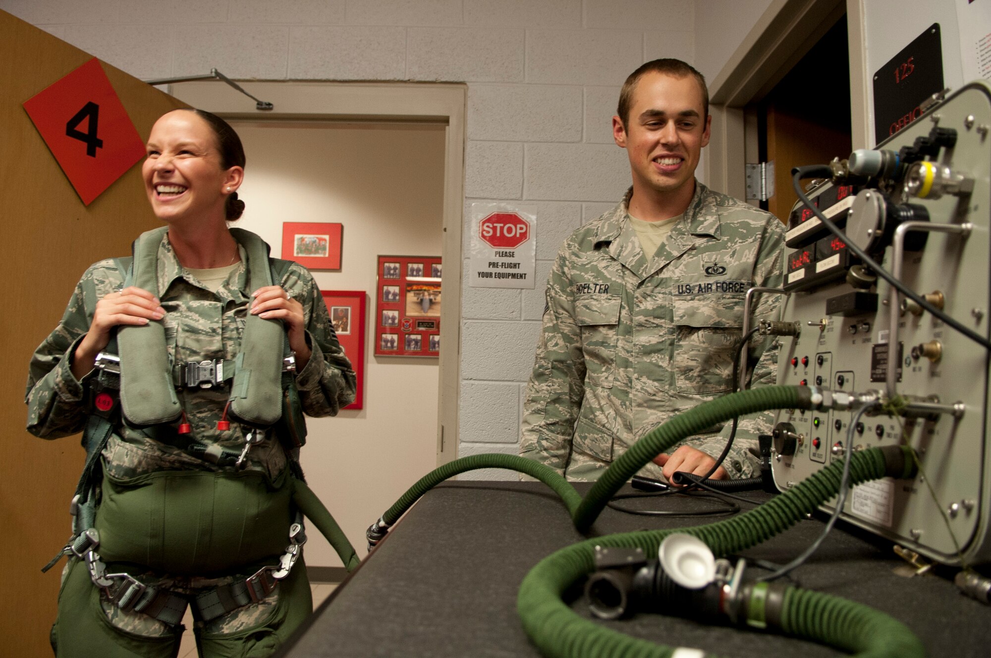 Staff Sgt. Amanda Armenti, 4th Medical Group bioenvironmental engineer, laughs as she experiences a G-Suit for the first time with the help of Staff Sgt. Dain Boelter, 4th Operations Squadron life support technician, as a part of an impromptu tour of the 333rd Fighter Squadron, 26 Aug 2015, at Seymour Johnson Air Force Base, North Carolina. This tour was part in an initiative by Col. Mark Slocum, 4th Fighter Wing commander, to get Airmen out to the fighter squadrons and flightline, who otherwise don’t get the chance.  (U.S. Air Force photo/Master Sgt. Jocelyn L. Rich-Pendracki)