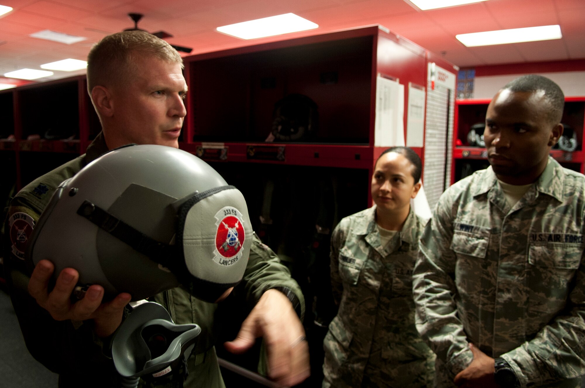 Lieutenant Col.  Frederick Haley III,  333rd Fighter Squadron commander, familiarizes bioenvironmental engineers from the 4th Medical Group with life support equipment during an impromptu tour of his squadron, 26 Aug 2015, at Seymour Johnson Air Force Base, North Carolina.  This tour was part of an initiative by Col. Mark Slocum, 4th Fighter Wing commander, to get Airmen out to the fighter squadrons and flightline, who otherwise don’t get the chance.  Although the primary mission if the U.S. Air Force is to “Fly, Flight & Win” there are many Airmen that support the flying mission from afar.  “It's great to get these Airmen near the flying mission, who normally don't get to see it up close” said Slocum. (U.S. Air Force photo/Master Sgt. Jocelyn L. Rich-Pendracki)