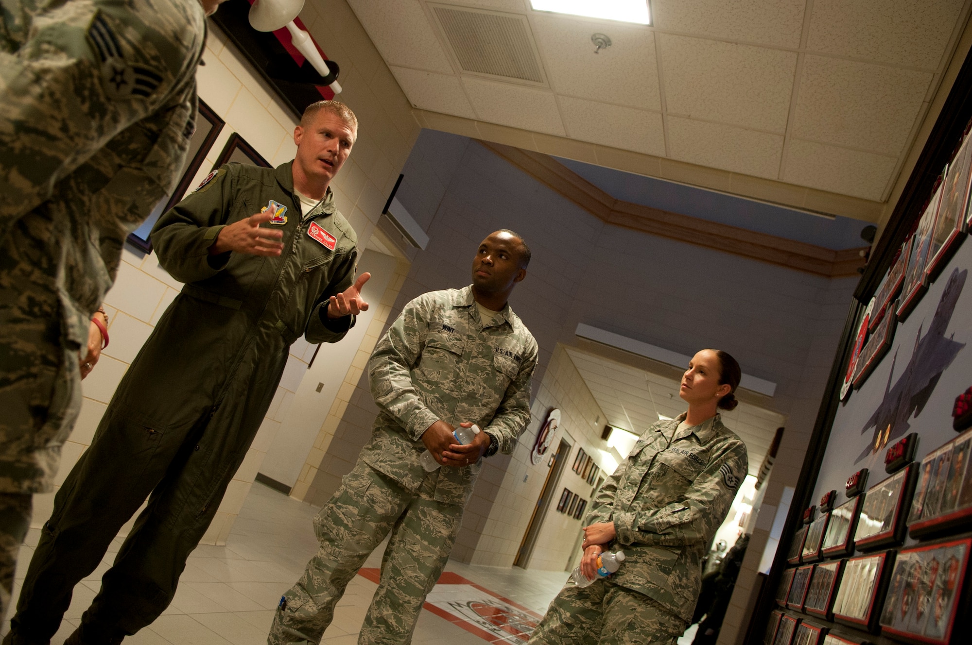 Lieutenant Col.  Frederick Haley III, 333rd Fighter Squadron commander, provides an impromptu tour of his squadron building to bioenvironmental engineers from the 4th Medical Group, 26 Aug 2015, at Seymour Johnson Air Force Base, North Carolina.  This tour was part of an initiative by the Col. Mark Slocum, 4th Fighter Wing commander, to get Airmen out to the fighter squadrons and flightline, who otherwise don’t get the chance.  Although the primary mission of the U.S. Air Force is to “Fly, Flight & Win” there are many Airmen that support the flying mission from afar.  “It's great to get these Airmen near the flying mission, who normally don't get to see it up close,” said Slocum. (U.S. Air Force photo/Master Sgt. Jocelyn L. Rich-Pendracki)