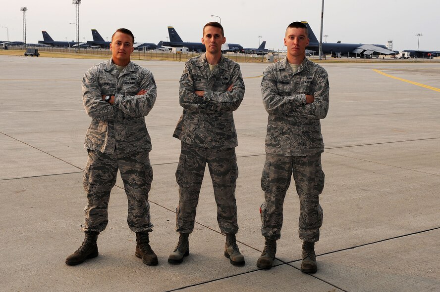 From left to right, Senior Airman Taylor Lancaster, Staff Sgt. Nicholas Tullis and Senior Airman James Booterbaugh, 5th Aircraft Maintenance nuclear/conventional aircraft crew chief team pose in front of the flightline at Minot Air Force Base, N.D., Aug. 21, 2015. This is the team’s first Global Strike Challenge and they look forward to competing for the first time. To prepare, they have been studying every day and self-evaluating each other on every single aircraft pre-flight card and every raid they do. They are 100 percent confident as they do this every day by demonstrating they are the best during every exercise they do. Now it’s time to put it on paper. (U.S. Air Force photo / Senior Airman Kristoffer Kaubisch)