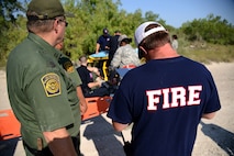 A U.S. Customs and Border Protection first responder, left, and Blake Ward, member of Kinney County Fire and Rescue and the on-scene commander, annotate actions and events during a major accident response exercise in Spofford, Texas, Aug. 26, 2015. Preventing mishaps involves identifying problem areas related to safety and correcting these hazards before someone gets hurt or equipment or aircraft are destroyed. Regardless of whether a hazard is identified prior to or after a mishap, safety related problems must be corrected as soon as possible after they have been identified. (U.S. Air Force photo by Tech Sgt. Steven R. Doty)(Released)