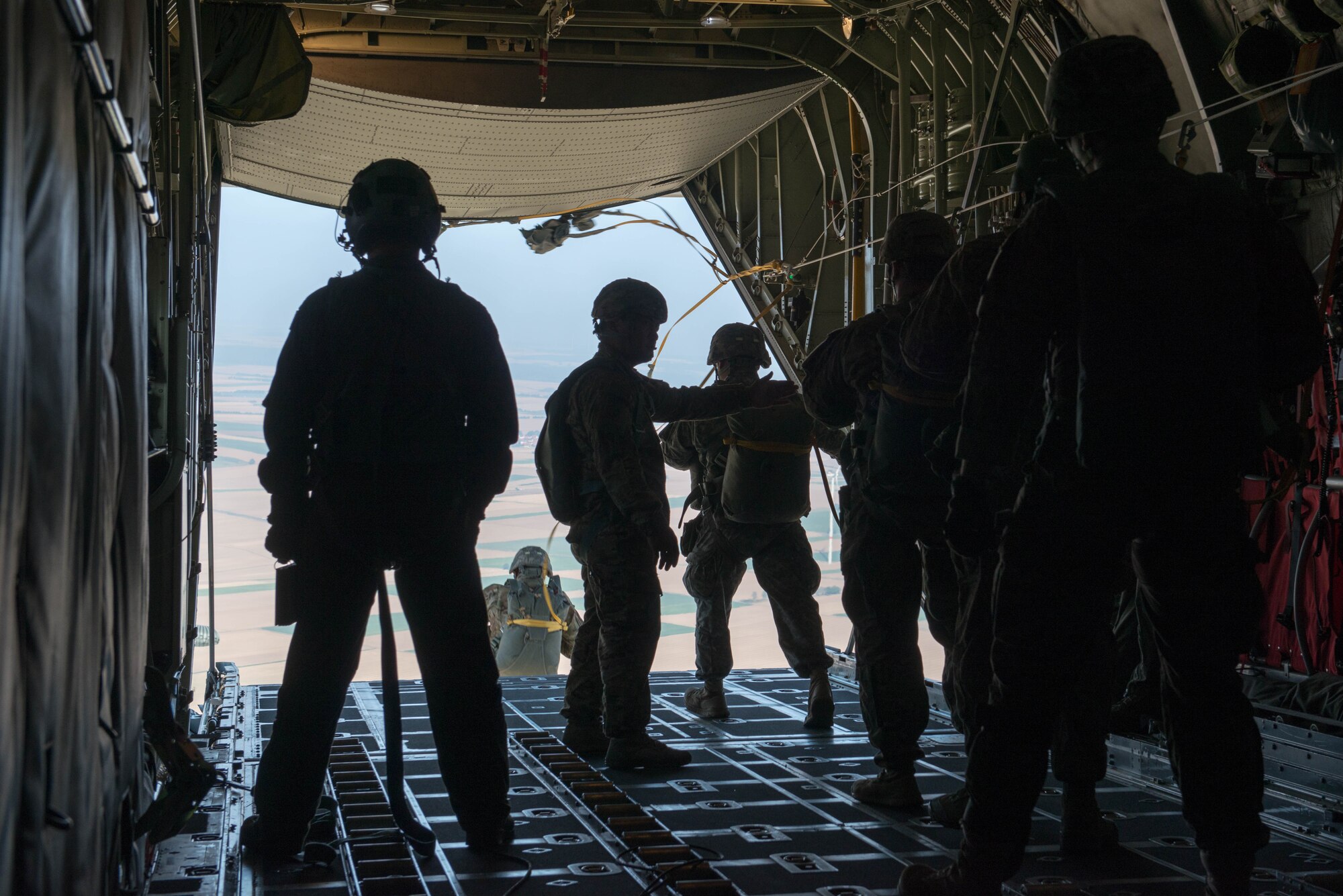 Members of the 5th Quartermaster Theater Aerial Delivery Company prepare to jump from a C-130 from the 934th Airlift Wing for an airdrop during exercise Swift Response at Ramstein AB, Germany. (U.S. Air Force photo by Trevor Saylor/Released)