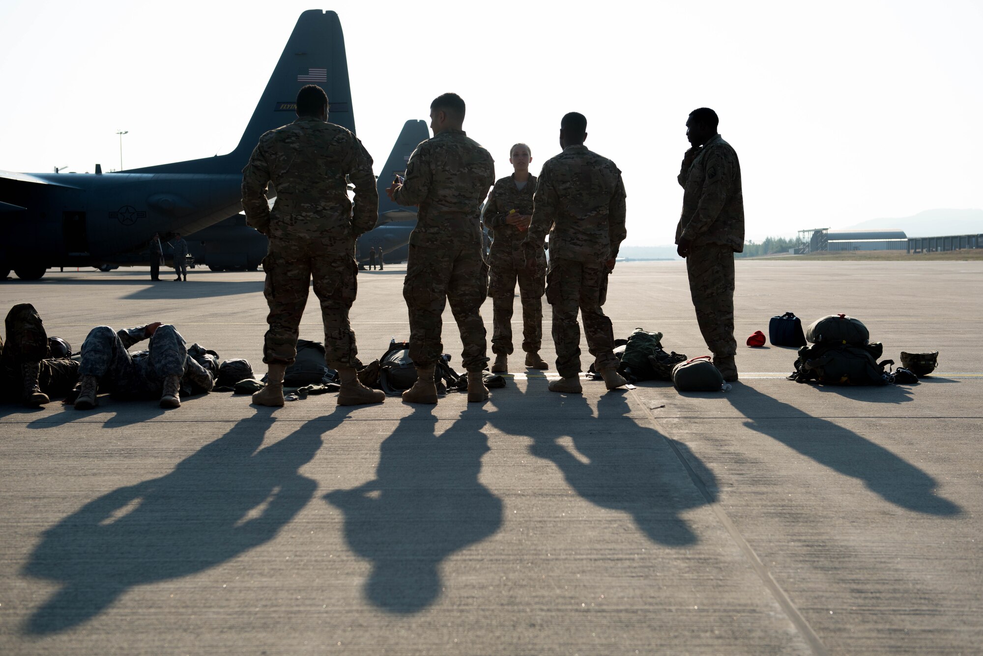 Members of the 5th Quartermaster Theater Aerial Delivery Company wait to load onto a C-130 from the 934th Airlift Wing for an airdrop during exercise Swift Response at Ramstein AB, Germany. (U.S. Air Force photo by Trevor Saylor/Released)