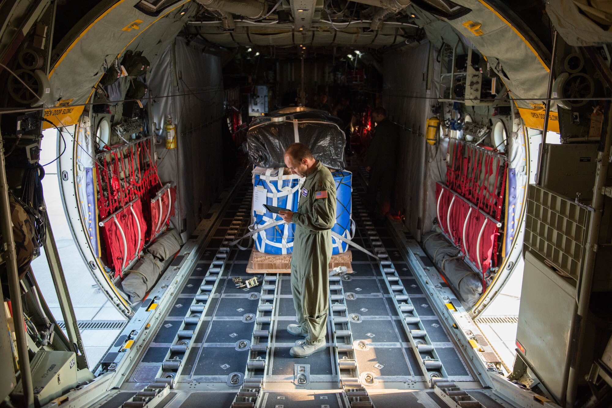 Maj. Rob Rettig, 96 AS pilot, goes over pre-flight papersork before an airdrop during exercise Swift Response 15 at Ramstein AB, Germany. (U.S. Air Force Photo by Staff Sgt. Trevor Saylor/Released)