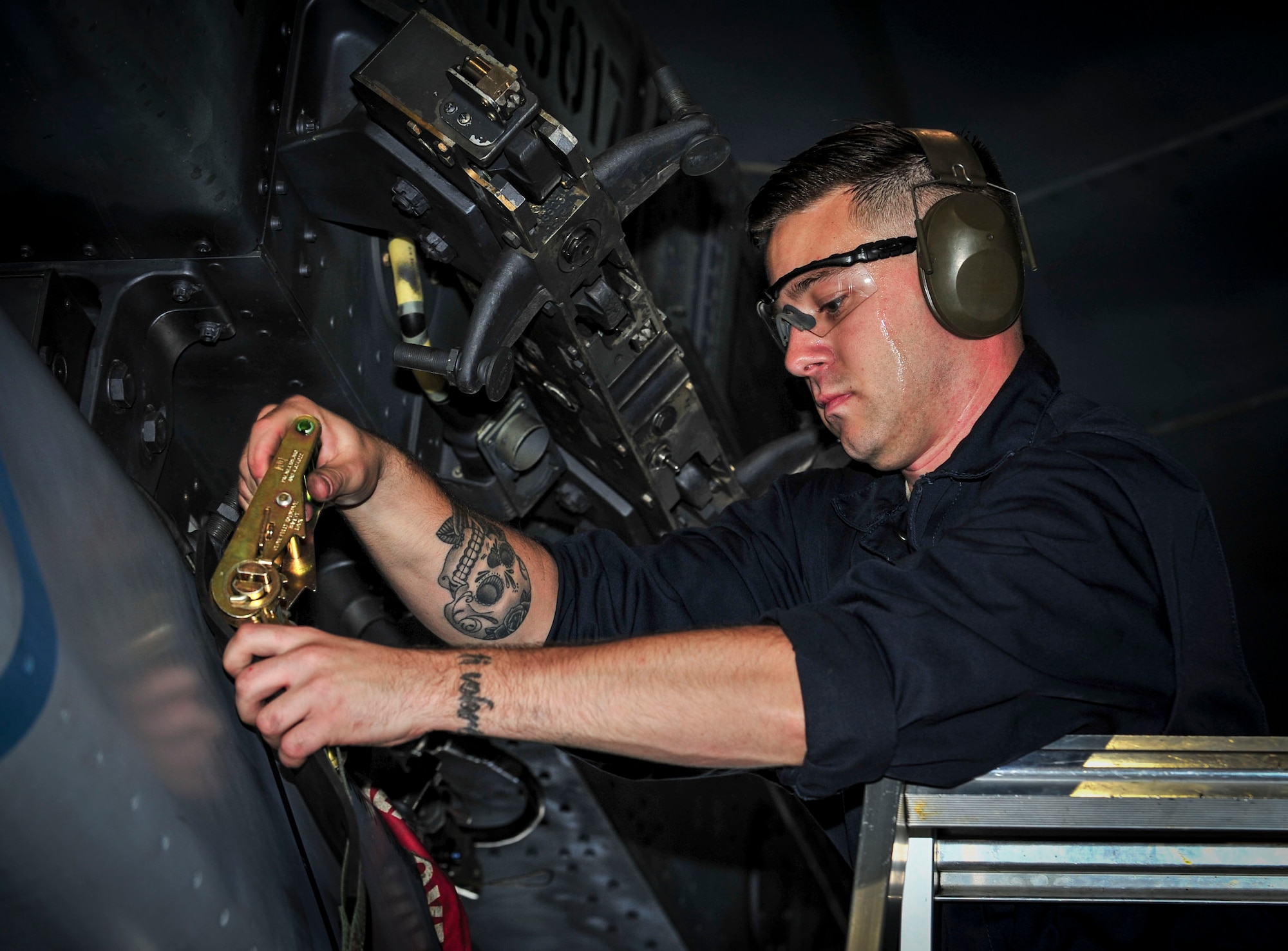 Staff Sgt. Robert Wagner Jr., 5th Aircraft Maintenance Squadron weapons load crew team chief, removes a strap from a B-52H Stratofortress weapon system at Minot Air Force Base, N.D., Aug. 24, 2015. Wagner and his team were required to load four weapons onto the aircraft as part of Air Force Global Strike Command’s Global Strike Challenge Competition and used constant communication to ensure the weapons were loaded quickly, safely and effectively. (U.S. Air Force photo/Senior Airman Stephanie Morris)