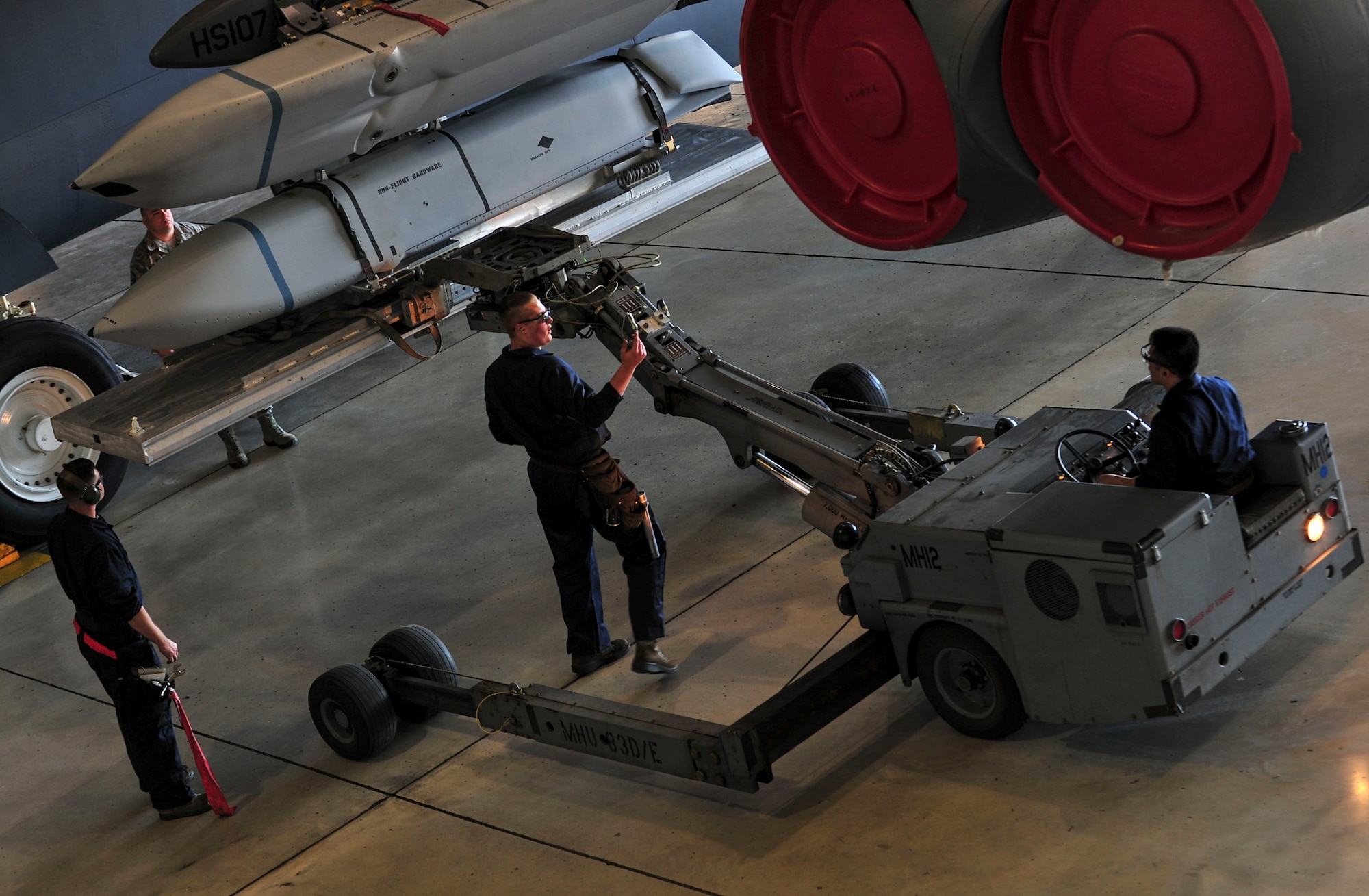 Members of the 5th Aircraft Maintenance Squadron maneuver a “jammer” under the wing of a B-52H Stratofortress at Minot Air Force Base, N.D., Aug. 24, 2015. The group was required to load four weapons onto the aircraft as part of Air Force Global Strike Command’s Global Strike Challenge Competition -- a task they completed in approximately 60 minutes. (U.S. Air Force photo/Senior Airman Stephanie Morris)