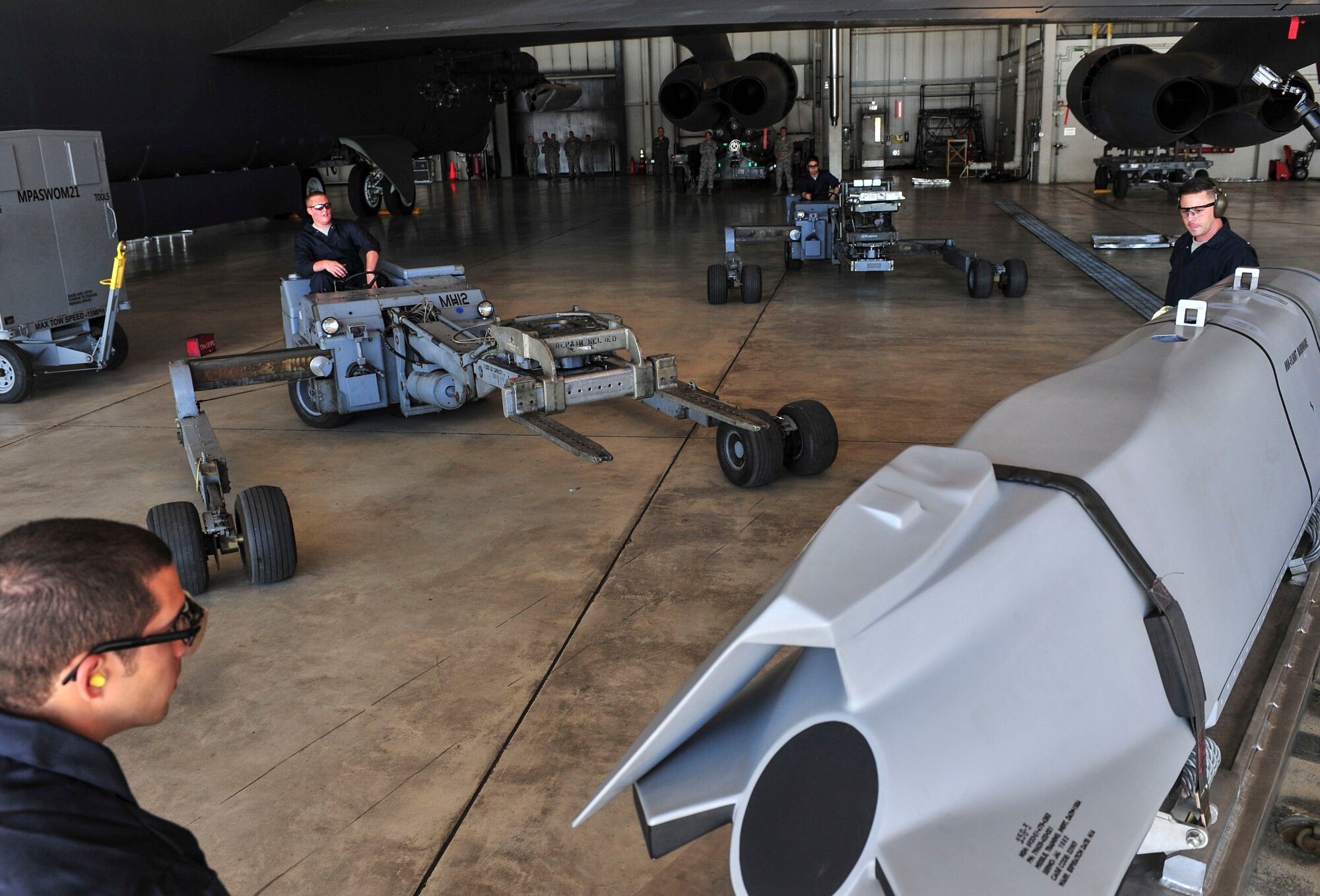 Members of the 5th Aircraft Maintenance Squadron maneuver a “jammer” to transport weapon systems to the wing of a B-52H Stratofortress at Minot Air Force Base, N.D., Aug. 24, 2015. The group was required to load four weapons onto the aircraft as part of Air Force Global Strike Command’s Global Strike Challenge Competition -- a task they completed in approximately 60 minutes. (U.S. Air Force photo/Senior Airman Stephanie Morris)