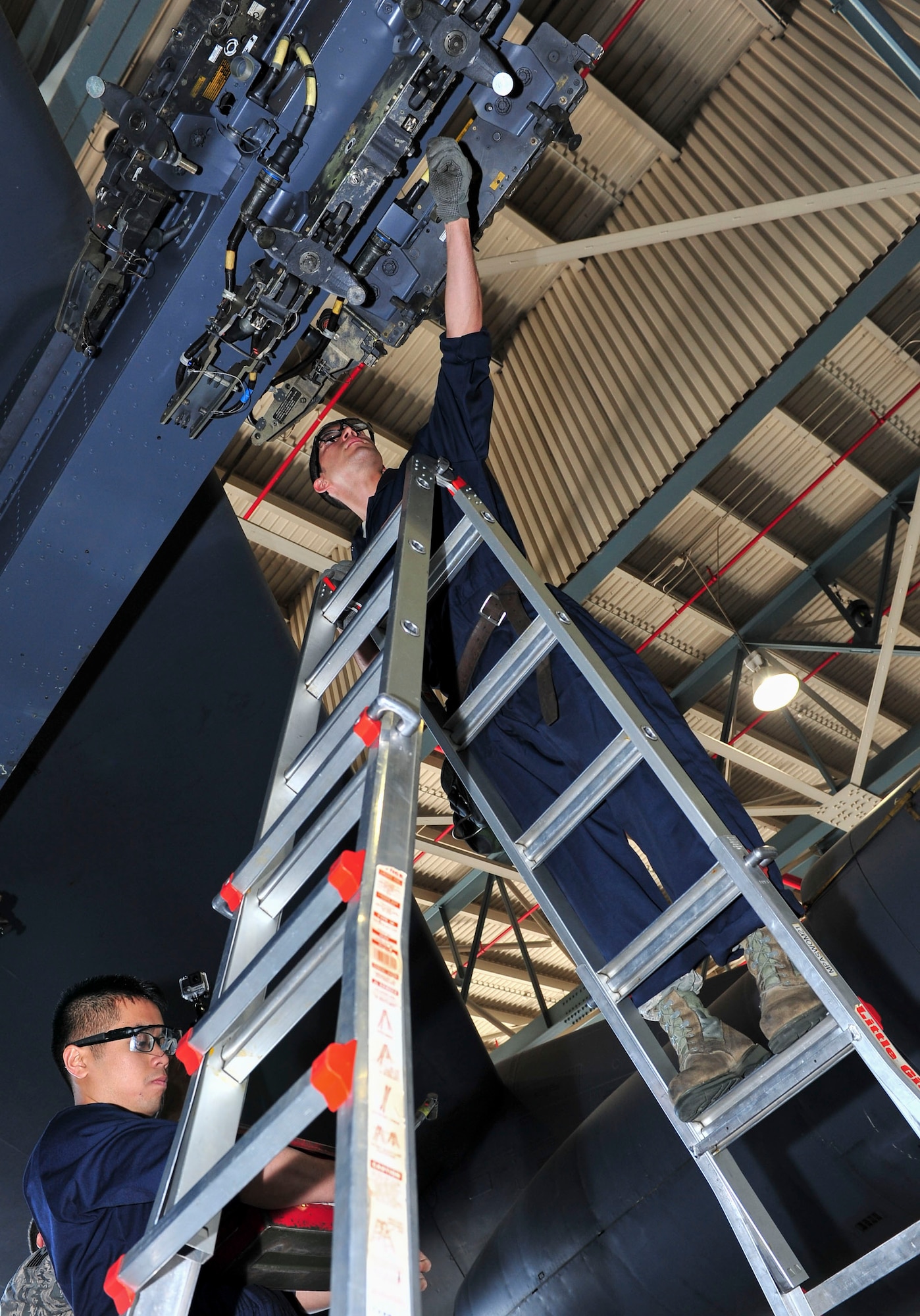 Senior Airman Alex Jimenez, 5th Aircraft Maintenance Squadron weapons load crew member, works with his team to load four weapon systems onto a B-52H Stratofortress at Minot Air Force Base, N.D., Aug. 24, 2015. Jimenez and his team were tested on their ability to quickly, safely and effectively load the weapons as part of Air Force Global Strike Command’s Global Strike Challenge Competition. (U.S. Air Force photo/Senior Airman Stephanie Morris)
