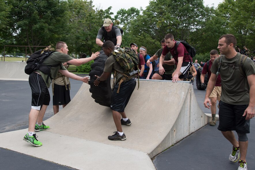 Airmen participate in a team activity during a Team Cohesion Challenge on base Aug. 24. The event was hosted by the 66th Force Support Squadron. (U.S. Air Force photo by Mark Herlihy)