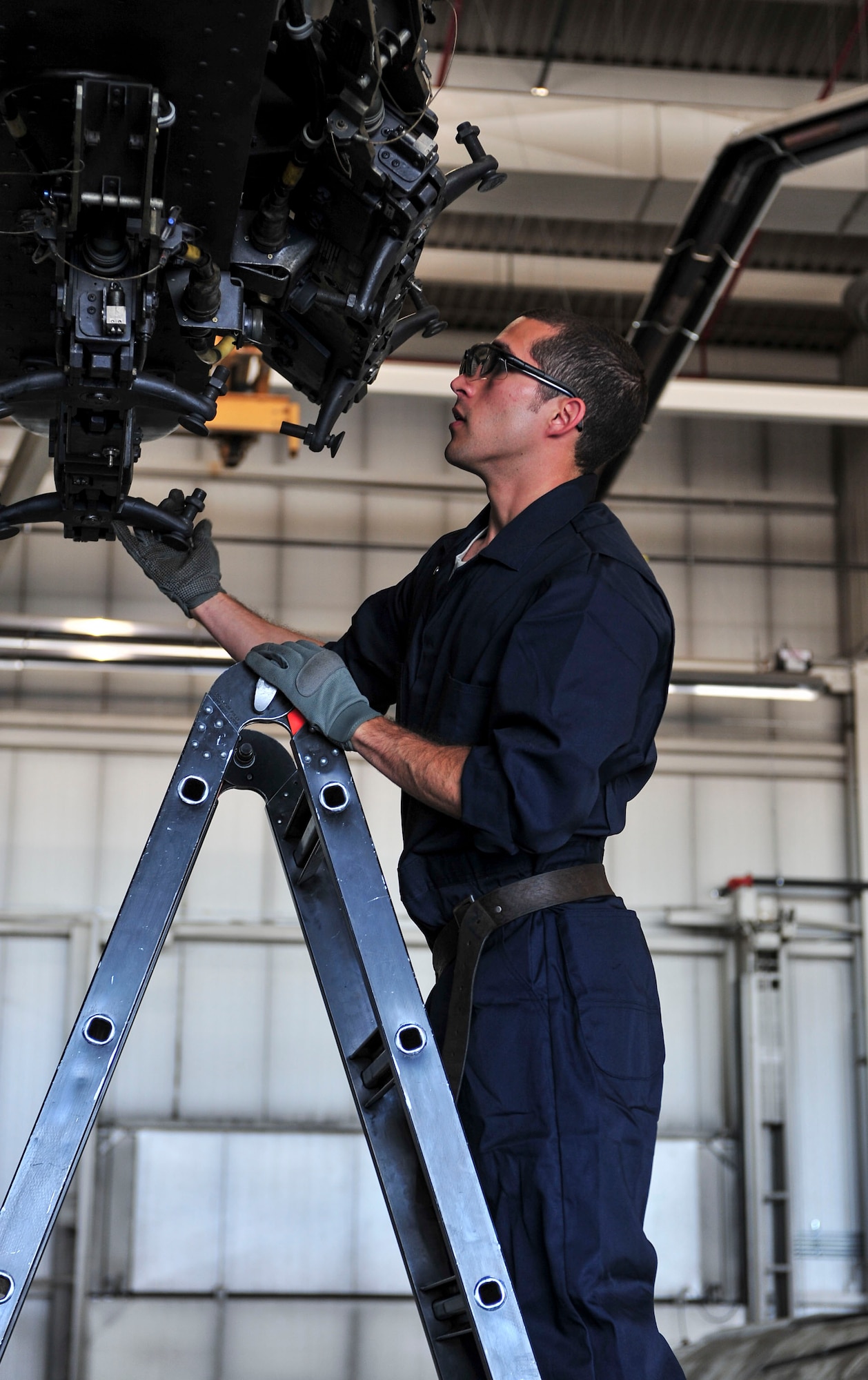Senior Airman Alex Jimenez, 5th Aircraft Maintenance Squadron weapons load crew member, works with his team to load four weapon systems onto a B-52H Stratofortress at Minot Air Force Base, N.D., Aug. 24, 2015. Jimenez and his team were tested on their ability to quickly, safely and effectively load the weapons as part of Air Force Global Strike Command’s Global Strike Challenge Competition. (U.S. Air Force photo/Senior Airman Stephanie Morris)