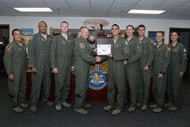 First Lt. Donald Lodge-Maragh, center, 85th Flying Training Squadron T-6 instructor pilot and flight scheduler, poses with Col. Darrell Judy, 47th Flying Training Wing vice commander, and Lt. Col. Arthur Alcantara  , 47th FTW director of staff, after accepting the “XLer of the Week” award, here, August 27, 2015. The “XLer” is a weekly award chosen by wing leadership and is presented to those who consistently make outstanding contributions to their unit and Laughlin. (U.S. Air Force photo by Airman 1st Class Brandon May)