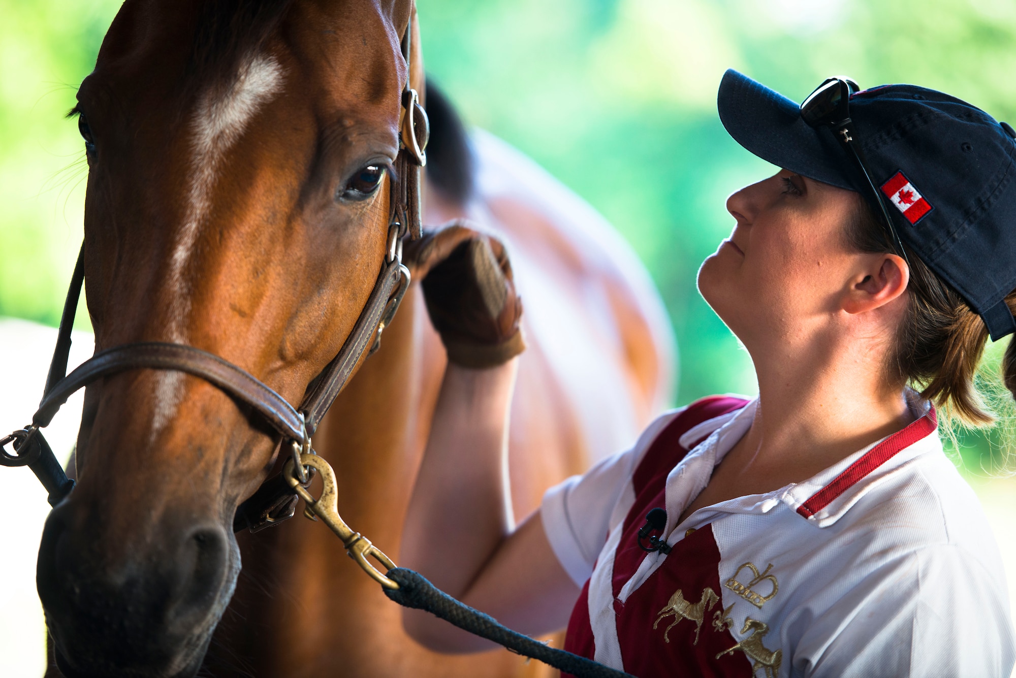 Capt. Lindsey Colburn, 11th Wing executive officer, inspects the bridle on her horse, Soon, prior to riding on Leighton Farm, Upper Marlboro, Md., Aug. 21, 2015. A properly mounted bridle ensures safety for the horse and rider. (U.S. Air Force photo by Staff Sgt. Chad C. Strohmeyer)(Released)