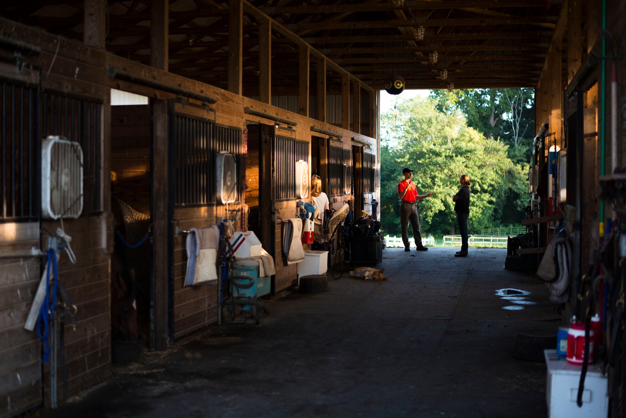 Equestrian riders talk prior to riding on Leighton Farm, Upper Marlboro, Md., Aug. 21, 2015. The horses are kept in a barn to ensure proper care and treatment is administered. (U.S. Air Force photo by Staff Sgt. Chad C. Strohmeyer)(Released)