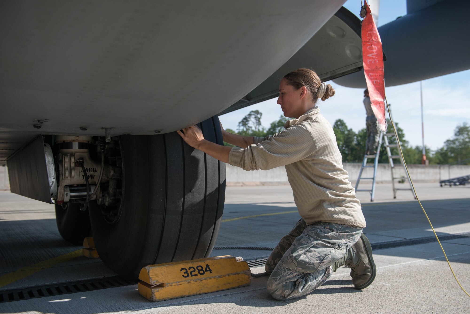 Master Sgt. Amber Meyer, 934th Aircraft Maintenance Squadron, checks the tires on a 934th C-130 at Ramstein AB, Germany during exercise Swift Response 15. (U.S. Air Force photo by Staff Sgt. Trevor Saylor/Released)
