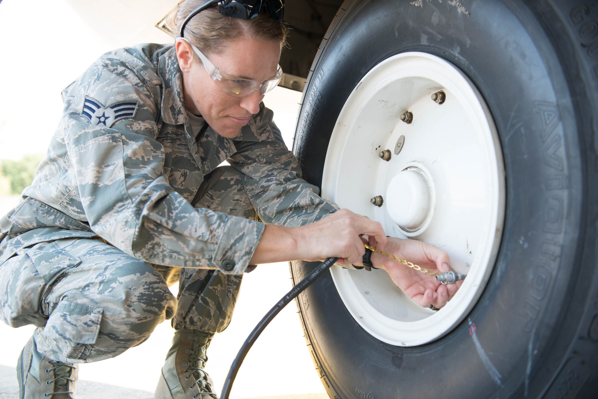 Senior Airman Sara Anderson, 934th Aircraft Maintenance Squadron, checks the tire pressure on a C-130 as part of a basic post-flight inspection at Ramstein AB, Germany during exercise Swift Response 15. (U.S. Air Force photo by Staff Sgt. Trevor Saylor/Released)
