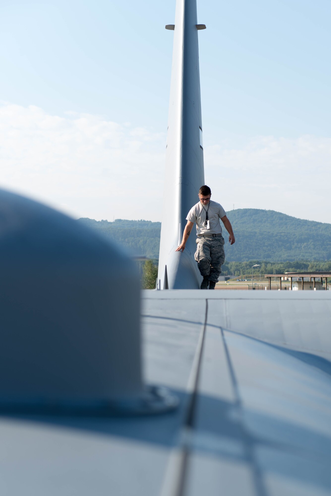 Senior Airman Jade Hamilton, 934th Aircraft Maintenance Squadron, inspects the wing of a C-130 at Ramstein AB, Germany during exercise Swift Response 15. (U.S. Air Force photo by Staff Sgt. Trevor Saylor/Released)