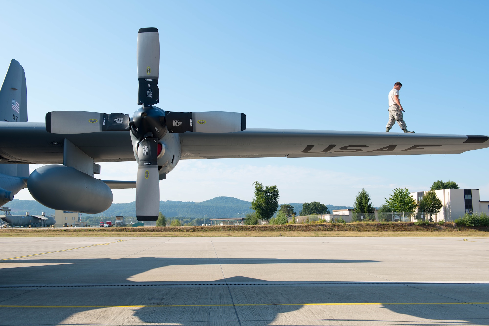 Senior Airman Jade Hamilton, 934th Aircraft Maintenance Squadron, inspects the wing of a C-130 at Ramstein AB, Germany during exercise Swift Response 15. (U.S. Air Force photo by Staff Sgt. Trevor Saylor/Released)