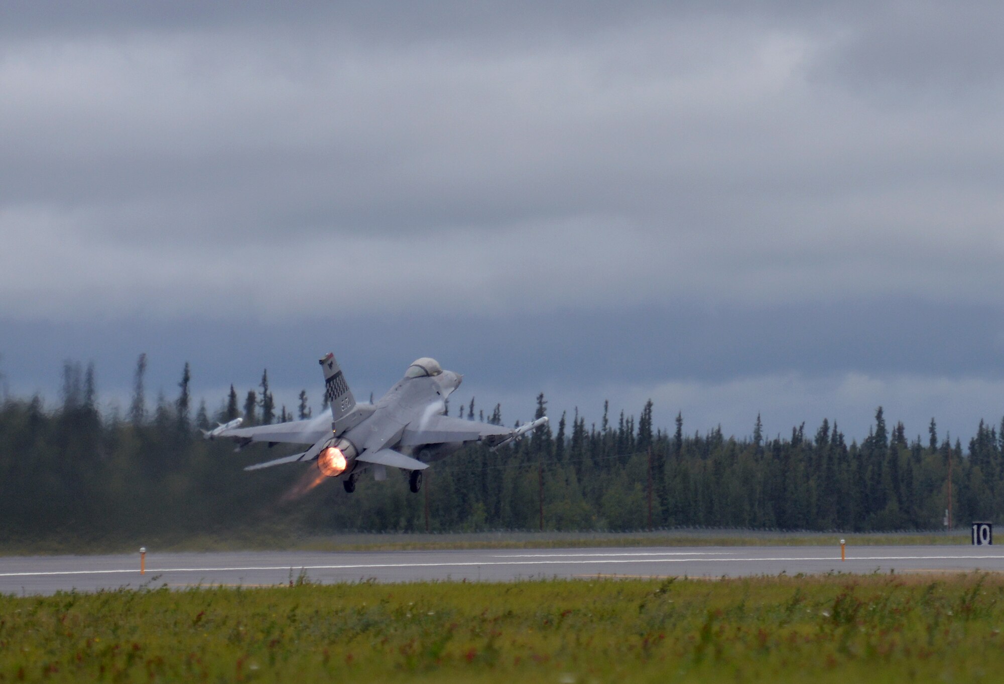 A U.S. Air Force F-16 Fighting Falcon assigned to the 36th Fighter Squadron from Osan Air Base, Republic of Korea, takes off from Eielson Air Force Base, Alaska, Aug. 10, 2015, during RED FLAG-Alaska (RF-A) 15-3. The Osan F-16s, as well as several A-10 Thunderbolt II aircraft from Osan's 25th Fighter Squadron, are deployed to Eielson for RF-A, a series of Pacific Air Forces commander-directed field training exercises for U.S. and partner nation forces, providing combined offensive counter-air, interdiction, close air support and large force employment training in a simulated combat environment. (U.S. Air Force photo by Master Sgt. Karen J. Tomasik/Released)