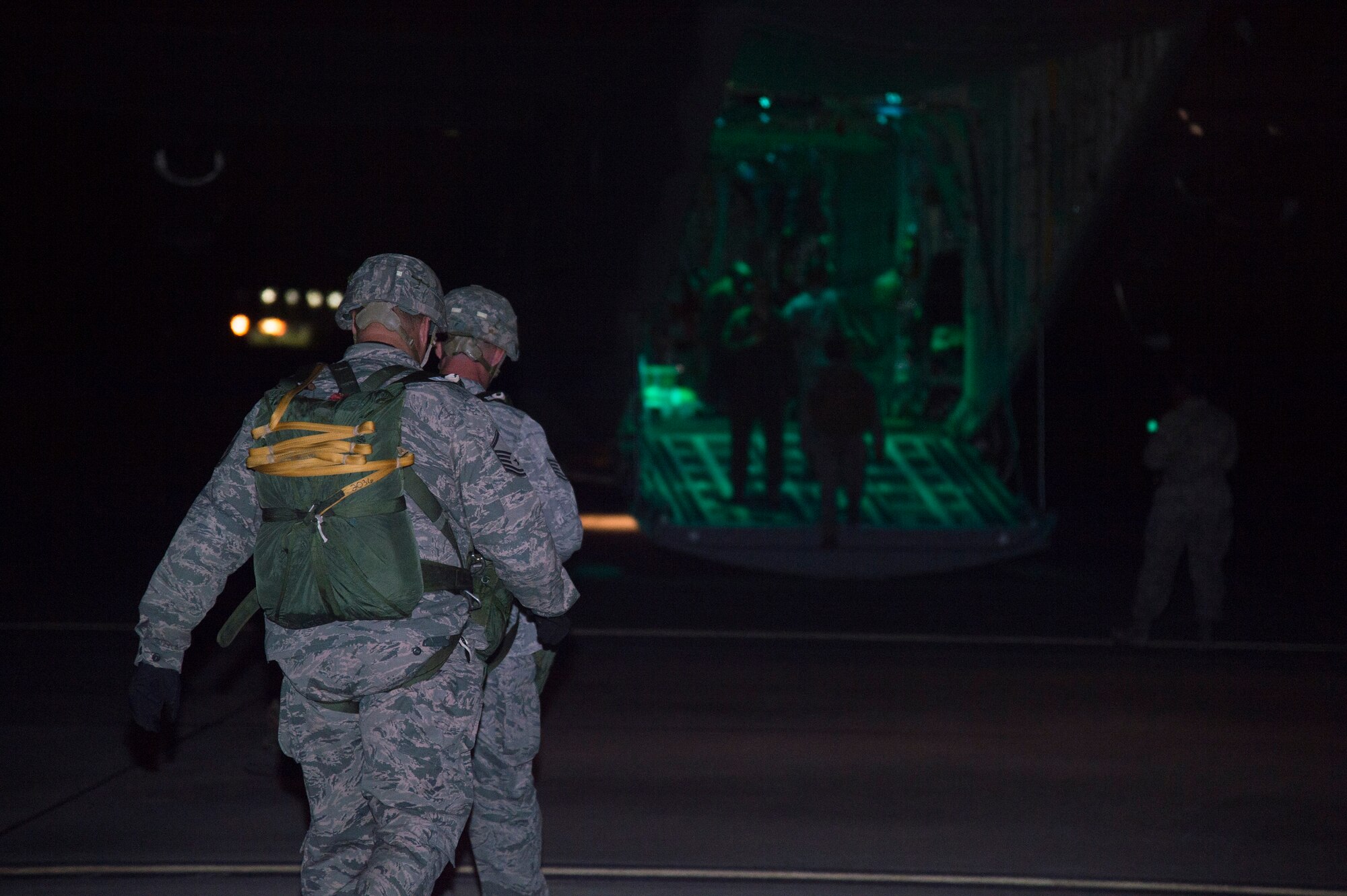 Members of the 820th Base Defense Group, head toward a HC-130J Combat King II before a static-line drop August 25, 2015, at Moody Air Force Base, Ga.  The jumpers performed a combat-equipment jump which includes the Airmen jumping with a parachute, ruck sack and rifle. (U.S. Air Force photo by Staff Sgt. Eric Summers Jr./Released)