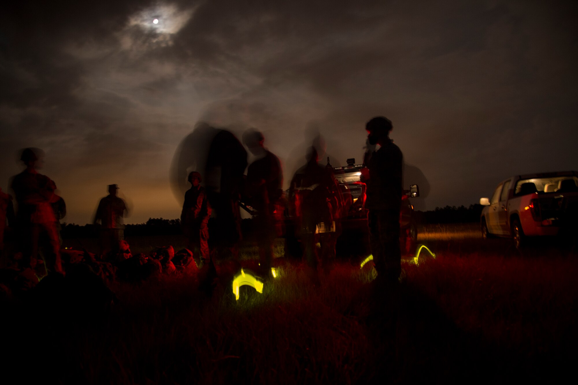 Airmen from the 820th Base Defense Group gather for accountability and discuss the static-line drop they accomplished minutes prior. The 820th BDG “Defenders” jump often to maintain their qualifications. (U.S. Air Force photo by Staff Sgt. Eric Summers Jr./Released)