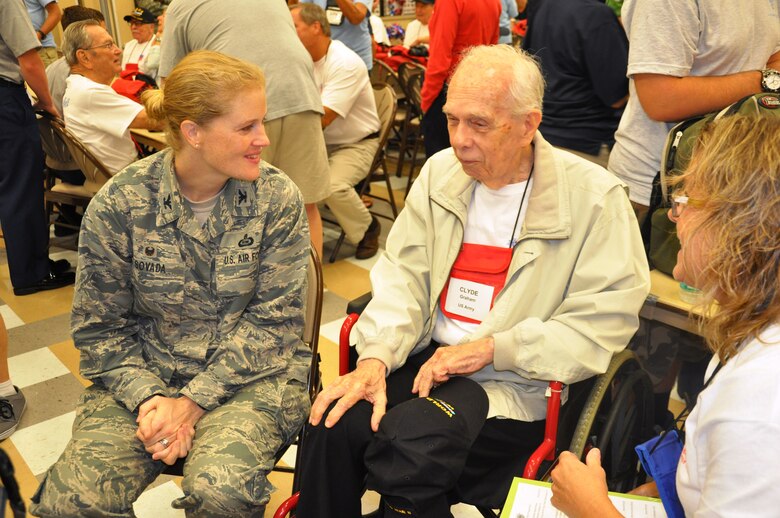 Col. Jennifer Sovada, Air Force Technical Applications Center commander, speaks with Clyde Graham, a World War II veteran, and his Honor Flight guardian Debbie Graham, right, at the Wickham Park Senior Center, Fla., Aug. 22, 2015. The Space Coast Honor Flight sent 21 World War II and four Korean War veterans to Washington D.C. to visit their war memorials in Washington D.C. (U.S. Air Force photo by Alicia Premo/Released)