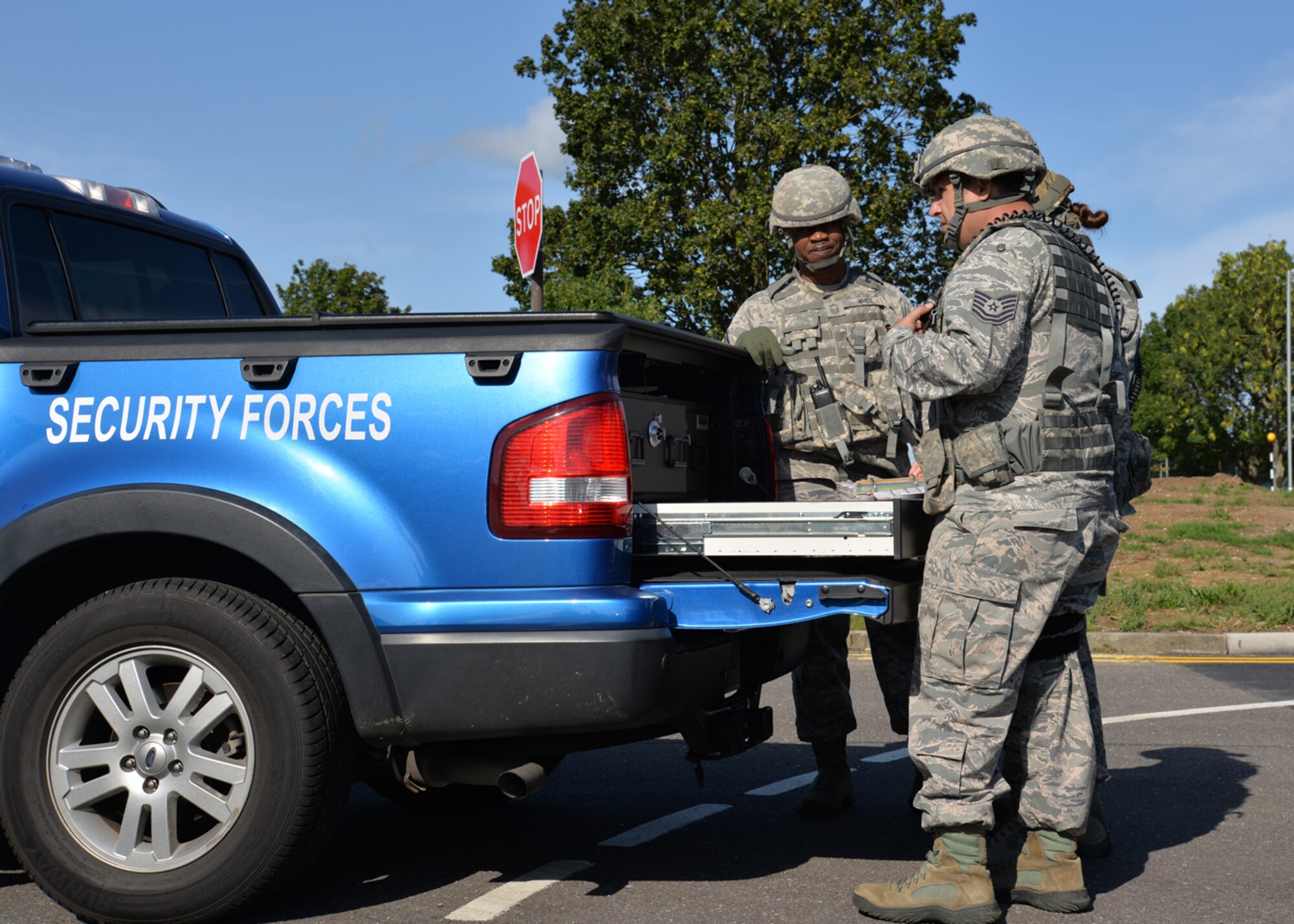 U.S. Air Force members from the 100th Security Forces Squadron use a plotting board at a temporary control point to provide information, including a safe route for other first responders, to the base defense operations center Aug. 25, 2015, during an exercise on RAF Mildenhall, England. As part of an emergency lockdown exercise, a simulated armed assailant was on base testing service members’ reactions to the scenario. (U.S. Air Force photo by Karen Abeyasekere/Released)