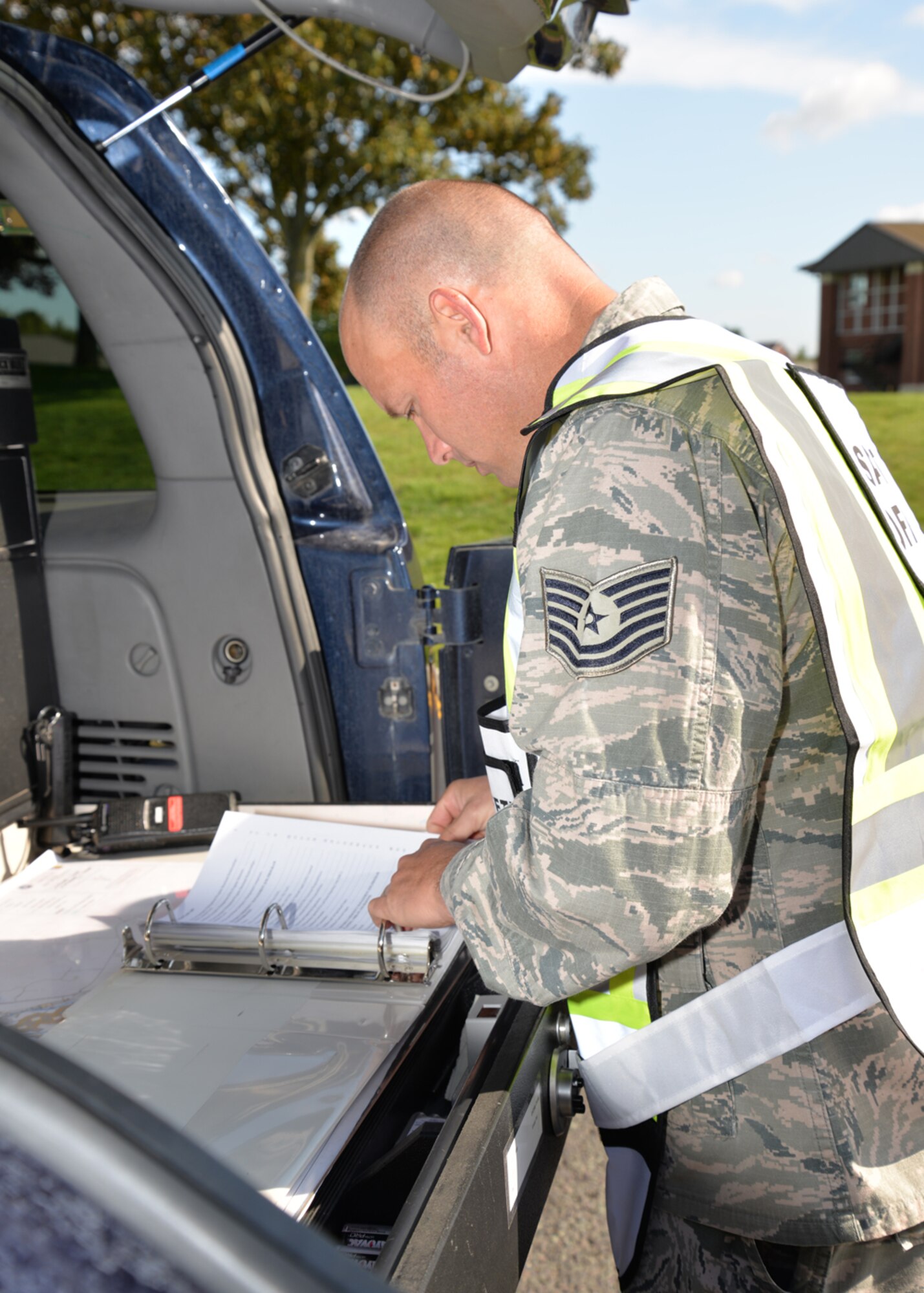 U.S. Air Force Tech. Sgt. Trey Sanders, 100th Civil Engineer Squadron Fire Department safety officer, runs an emergency checklist for an active shooter exercise Aug. 25, 2015, on RAF Mildenhall, England. The exercise was conducted to test 100th Security Forces Squadron, 100th Civil Engineer Squadron Fire Department and 48th Medical Group personnel on their response to an active shooter incident. (U.S. Air Force photo by Karen Abeyasekere/Released)