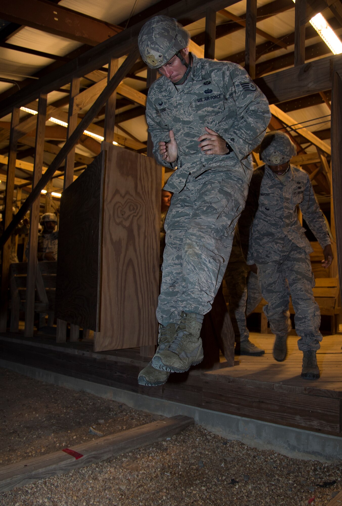 U.S. Staff Sgt. Michael Kearns, 822d Base Defense Squadron, practices exiting a simulated C-17 door before a night static line drop Aug. 25, 2015, at Moody Air Force Base Ga. The jumpers descend from approximately 1,200 feet and make contact traveling at approximately 14 to 17 miles per hour. (U.S. Air Force photo by Staff Sgt. Eric Summers Jr./Released)