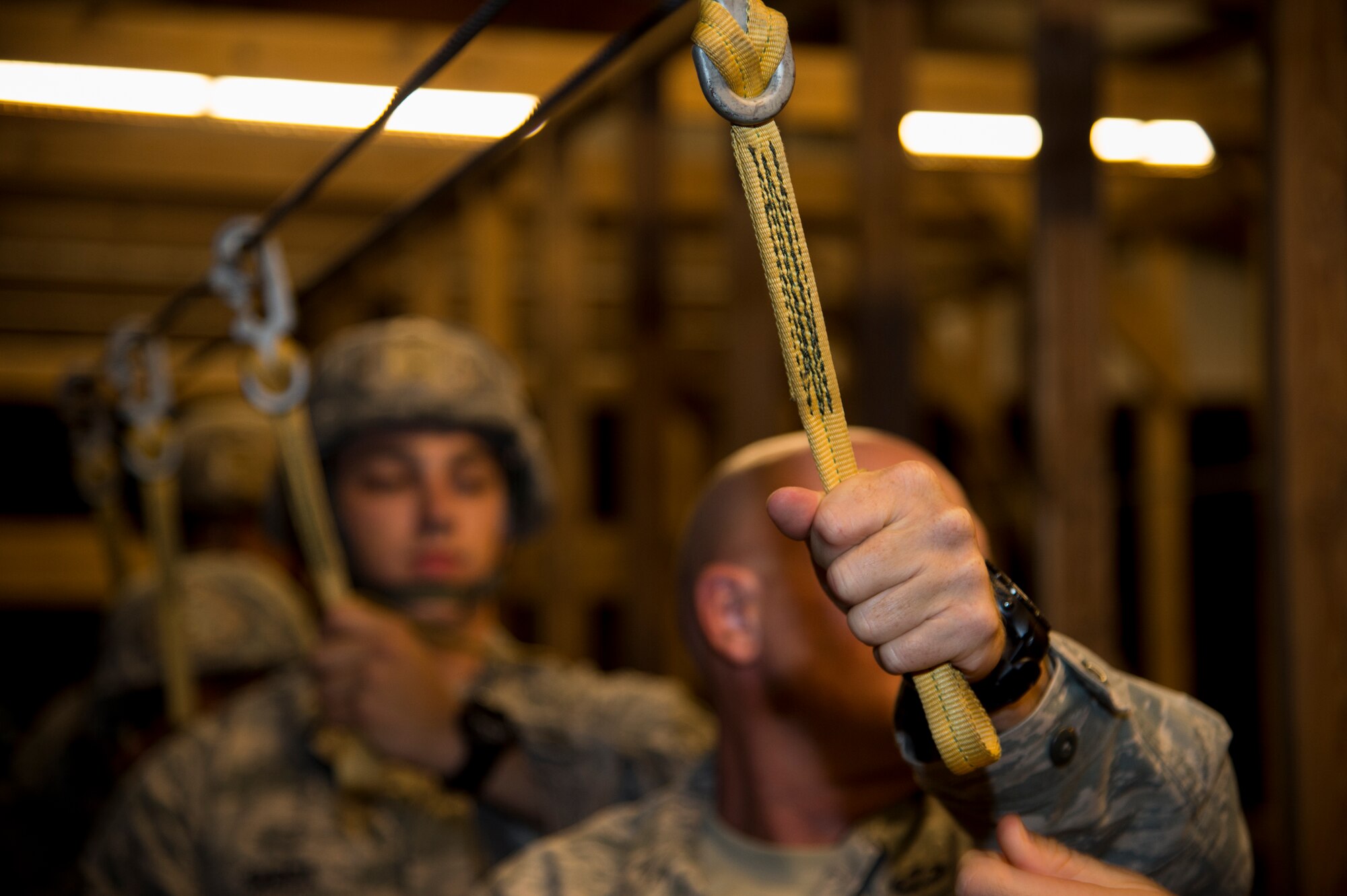Master Sgt. David Brown, 820th Combat Operations Squadron, holds a static line before exiting a simulated C-17 door August 25, 2015, at Moody Air Force Base, Ga. The Airmen practice proper landing techniques to mitigate injuries. (U.S. Air Force photo by Staff Sgt. Eric Summers Jr./Released)
