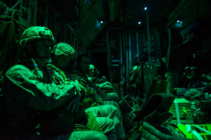 Airmen from the 820th Base Defense Group wait onboard a HC-130J Combat King II prior to performing a static line combat-equipment jump Aug. 25, 2015, at Moody Air Force Base, Ga. The jumpers performed combat- equipment jumps with a parachute, ruck sack and rifle. (U.S. Air Force photo by Airman 1st Class Ceaira Tinsley/Released)