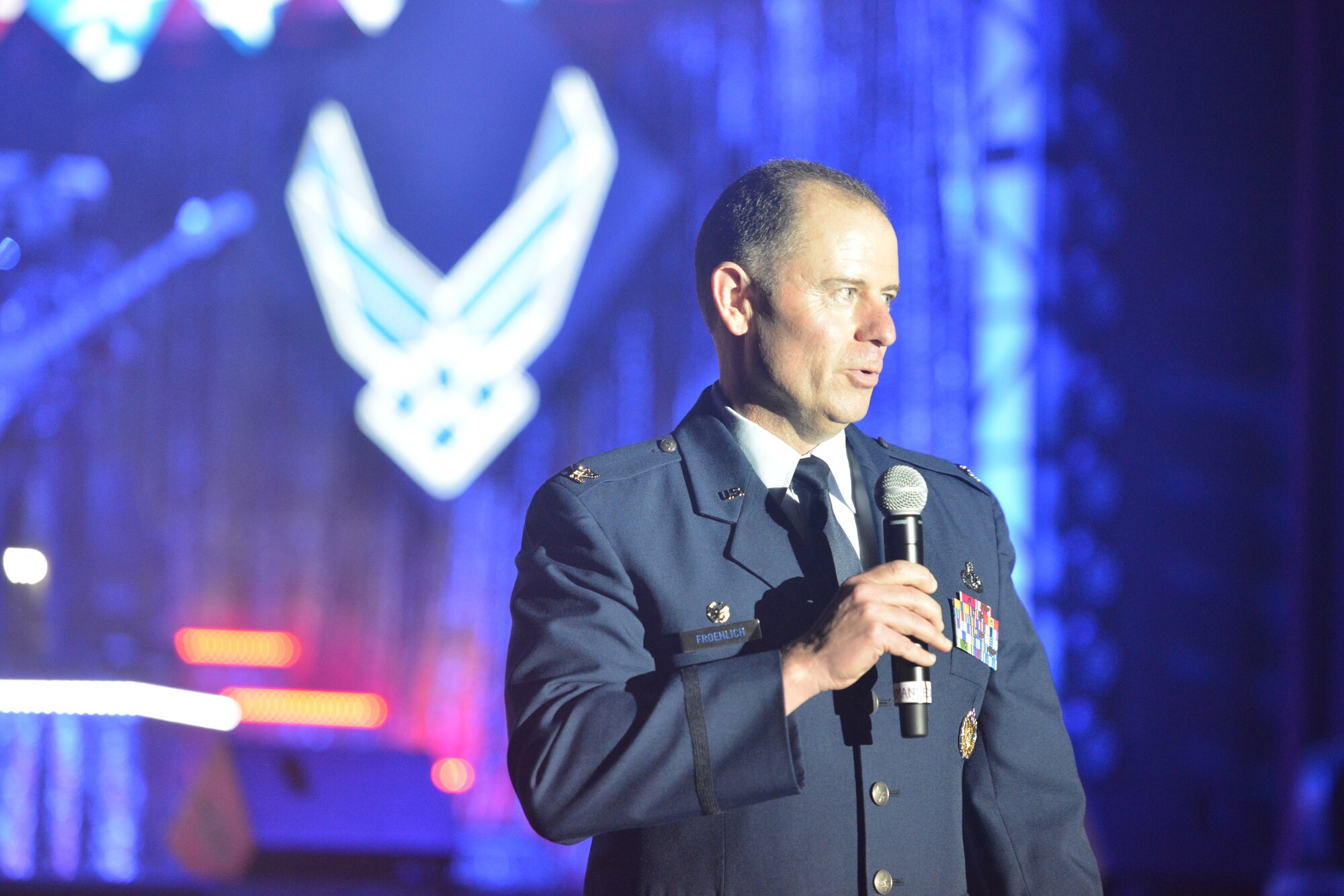 Col. Eric Froehlich, 377th Air Base Wing commander, greets the audience at the Tops in Blue performance Aug. 25 at Kiva Auditorium in downtown Albuquerque. Tops in Blue is the Air Force's premier entertainment showcase, and is one of the oldest and most widely traveled entertainment groups of its kind. Composed of 40 singers, musicians, dancers and technicians, Tops in Blue has performed for audiences in more than 120 locations throughout the U.S. and more than 25 foreign countries. (Photo by Todd Berenger)  