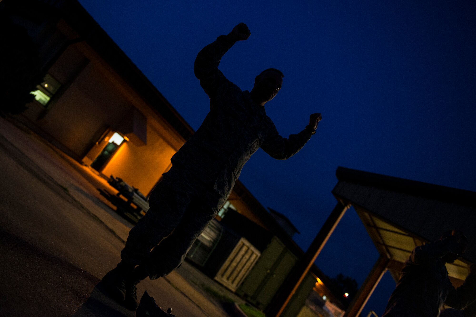 U.S. Air Force Col. Eric Trychon, 93d Air Ground Operations Wing vice commander, practices emergency landing and safety procedures for a static line combat-equipment jump Aug. 25, 2015, at Moody Air Force Base, Ga. Jumpers from the 820th Base Defense Group make contact with the ground at a speed of approximately 14 to 17 miles per hour and proper landing is imperative to avoid injury. (U.S. Air Force photo by Airman 1st Class Ceaira Tinsley/Released)
