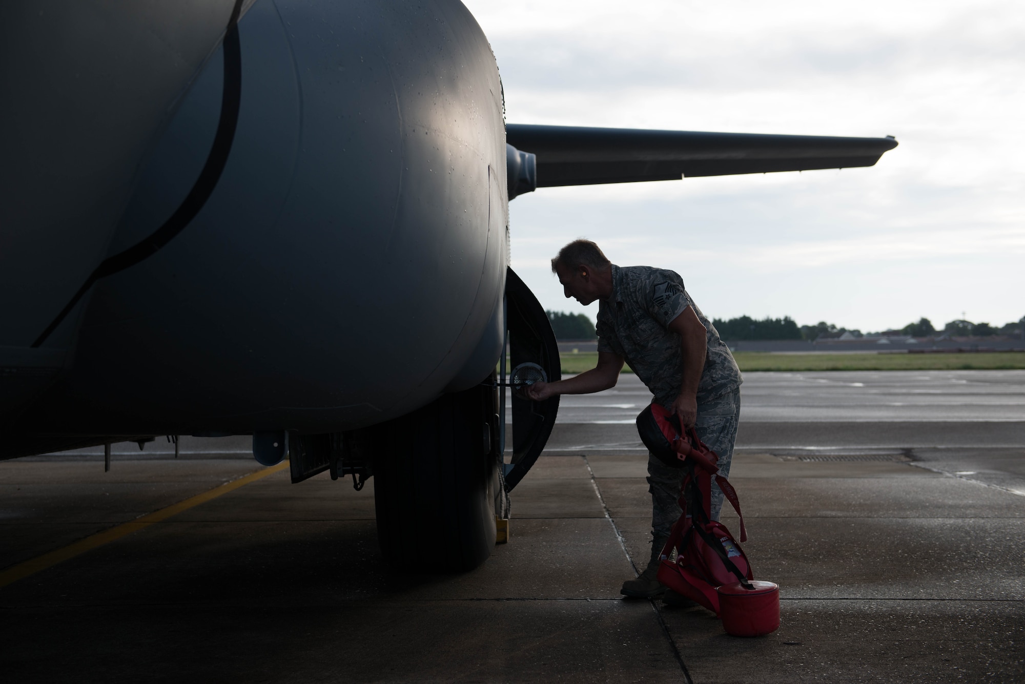Master Sgt. Dave Bugni, 934th Aircraft Maintenance Squadron, preflights a C-130 en route to Exercise Swift Response 15. (Air Force Photo/Staff Sgt. Trevor Saylor/Released) 