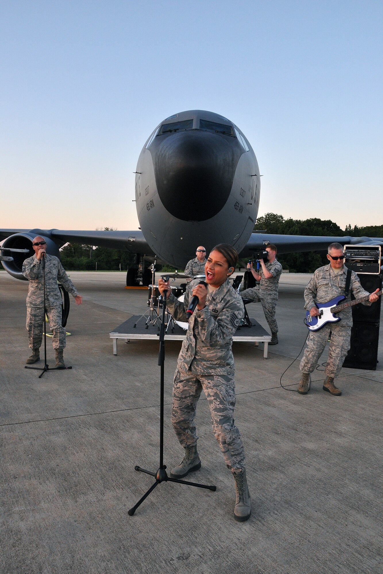 The U.S. Air Force band Max Impact performs in front of a 459th Air Refueling Wing KC-135R Stratocaster during production of their up-and-coming music video on the Joint Base Andrews flightline Aug. 26, 2015. Members of 459th Maintenance Group helped position the aircraft to set the stage for the media event. (U.S. Air Force photo/Kat Lynn Justen)