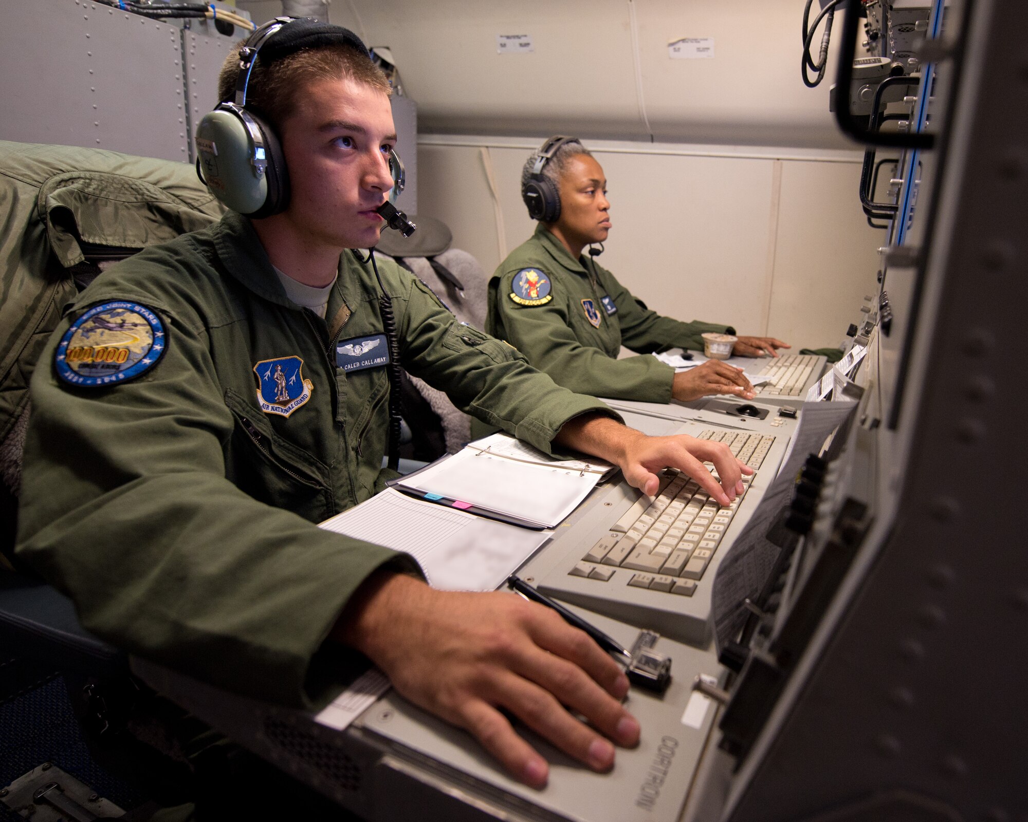 U.S. Air Force Senior Airman Caleb Callaway, left, and Senior Master Sgt. Lynda Washington, airborne operations technicians with the 116th Air Control Wing (ACW), Georgia Air National Guard, monitor tracking data from their operator work stations aboard an E-8C Joint STARS during a mission in the Boars Nest 2015 exercise, Robins Air Force Base, Ga., Aug. 20, 2015. The 116th ACW hosted the eighth annual Boars Nest Large Force Exercise bringing together more than 20 joint-force units and 55 different aircraft for aircrew training in a realistic land and maritime threat environment. Crews flying the E-8C Joint STARS manned platform, used their unique battle management, command and control, intelligence, surveillance and reconnaissance capabilities, integrated with other Air National Guard, Air Force, Navy, and Marine aircraft, to complete maritime and land-based missions during the exercise. (U.S. Air National Guard photo by Senior Master Sgt. Roger Parsons/Released) (Portions of photo blurred for security purposes)