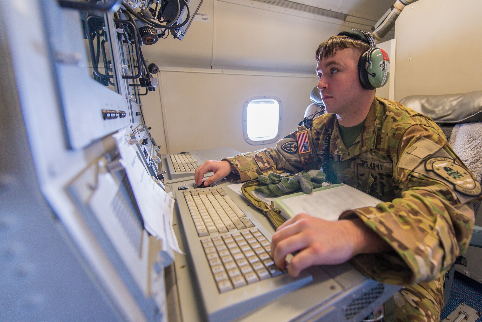 U.S. Army Sgt. Jason Horton, an airborne target surveillance supervisor with Army JSTARS, monitors tracking information from an operator work station aboard an E-8C Joint STARS during a mission in the Boars Nest 2015 exercise, Robins Air Force Base, Ga., Aug. 20, 2015. The 116th Air Control Wing, Georgia Air National Guard, hosted the eighth annual Boars Nest Large Force Exercise bringing together more than 20 joint-force units and 55 different aircraft for aircrew training in a realistic land and maritime threat environment. Crews flying the E-8C Joint STARS manned platform, used their unique battle management, command and control, intelligence, surveillance and reconnaissance capabilities, integrated with other Air National Guard, Air Force, Navy, and Marine aircraft, to complete maritime and land-based missions during the exercise. (U.S. Air National Guard photo by Senior Master Sgt. Roger Parsons/Released) (Portions of photo blurred for security purposes)