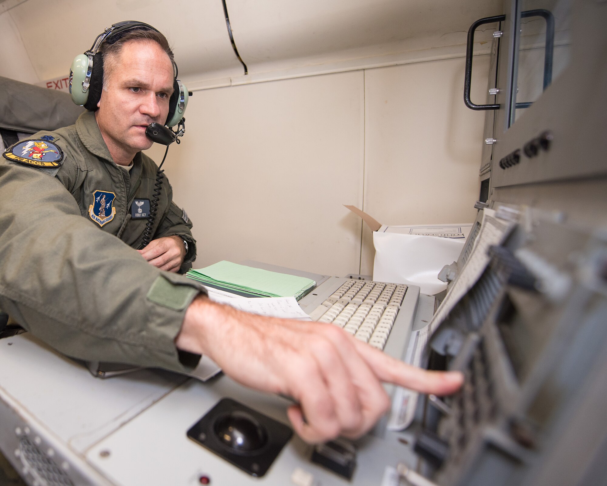 U.S. Air Force Lt. Col. Robby Key, mission crew commander with the 116th Air Control Wing (ACW), Georgia Air National Guard, inputs data and monitors tracking information from an operator work station aboard an E-8C Joint STARS during a mission in the Boars Nest 2015 exercise, Robins Air Force Base, Ga., Aug. 20, 2015. The 116th ACW hosted the eighth annual Boars Nest Large Force Exercise bringing together more than 20 joint-force units and 55 different aircraft for aircrew training in a realistic land and maritime threat environment. Crews flying the E-8C Joint STARS manned platform, used their unique battle management, command and control, intelligence, surveillance and reconnaissance capabilities, integrated with other Air National Guard, Air Force, Navy, and Marine aircraft, to complete maritime and land-based missions during the exercise. (U.S. Air National Guard photo by Senior Master Sgt. Roger Parsons/Released)