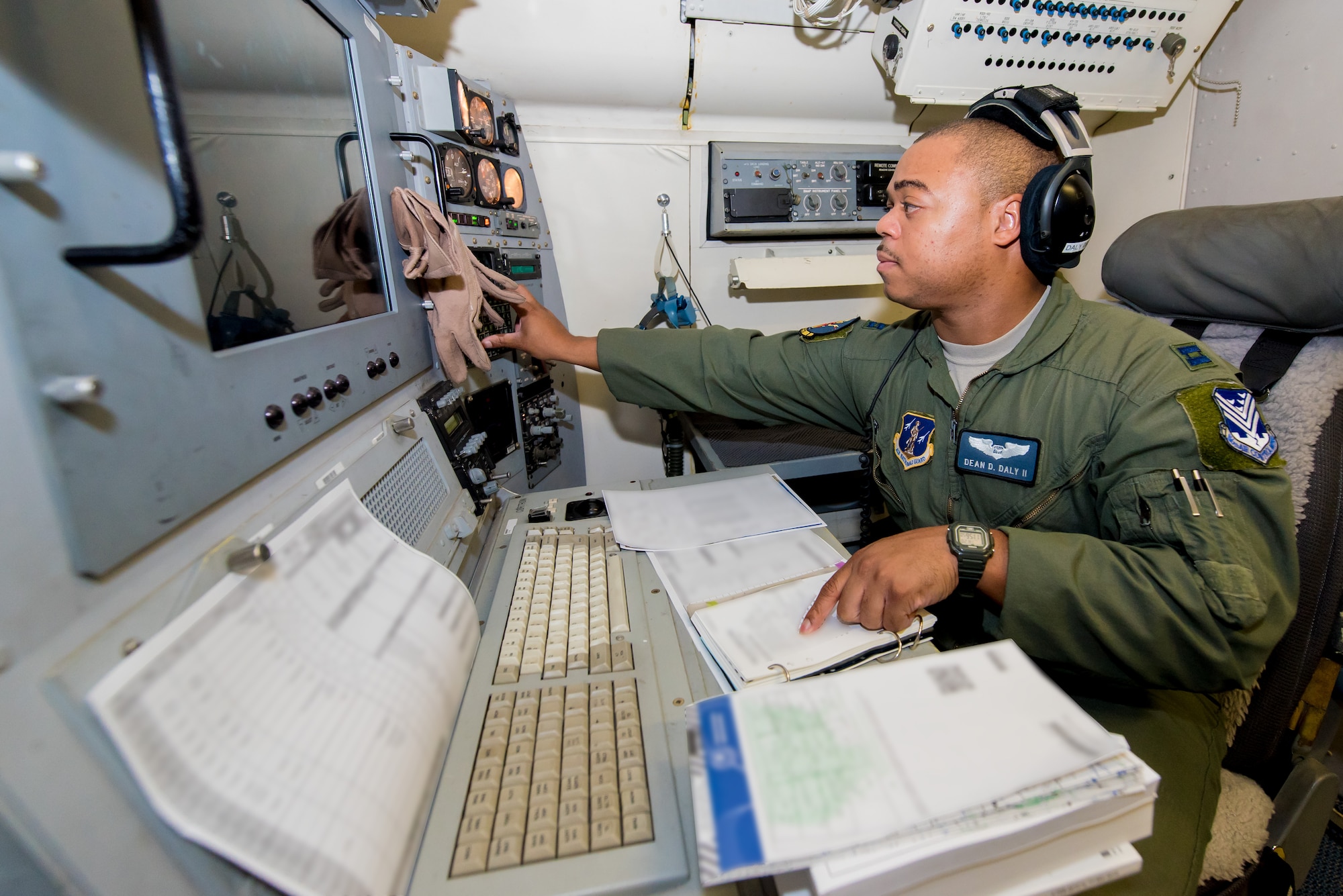 U.S. Air Force Capt. Dean Daly II, navigator with the 116th Air Control Wing (ACW), Georgia Air National Guard, inputs coordinates and performs a systems check aboard an E-8C Joint STARS prior to a mission in the Boars Nest 2015 exercise, Robins Air Force Base, Ga., Aug. 20, 2015. The 116th ACW hosted the eighth annual Boars Nest Large Force Exercise bringing together more than 20 joint-force units and 55 different aircraft for aircrew training in a realistic land and maritime threat environment. Crews flying the E-8C Joint STARS manned platform, used their unique battle management, command and control, intelligence, surveillance and reconnaissance capabilities, integrated with other Air National Guard, Air Force, Navy, and Marine aircraft, to complete maritime and land-based missions during the exercise. (U.S. Air National Guard photo by Senior Master Sgt. Roger Parsons/Released) (Portions of photo blurred for security purposes)