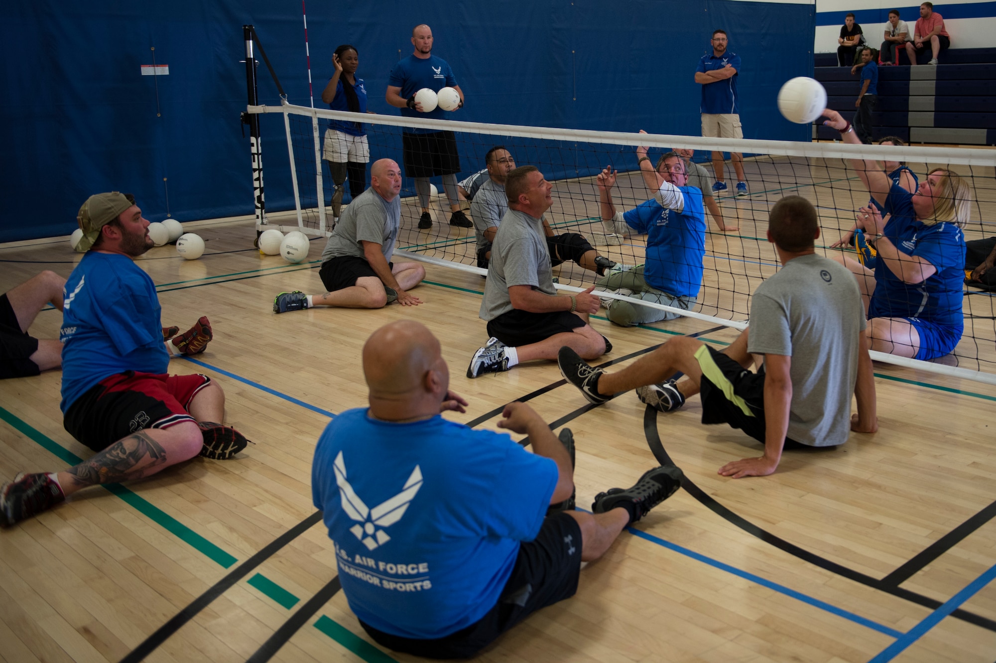 Wounded Warriors play sitting volleyball during the Air Force Wounded Warrior (AFW2) Program Warrior Care event, Aug. 26, 2015 at Joint Base Lewis-McChord, Wash. The Warrior Care event features adaptive and rehabilitative sports activities, career readiness, recovering Airman mentorship and caregiver training. (U.S. Air Force photo by Staff Sgt. Ashley Hyatt)