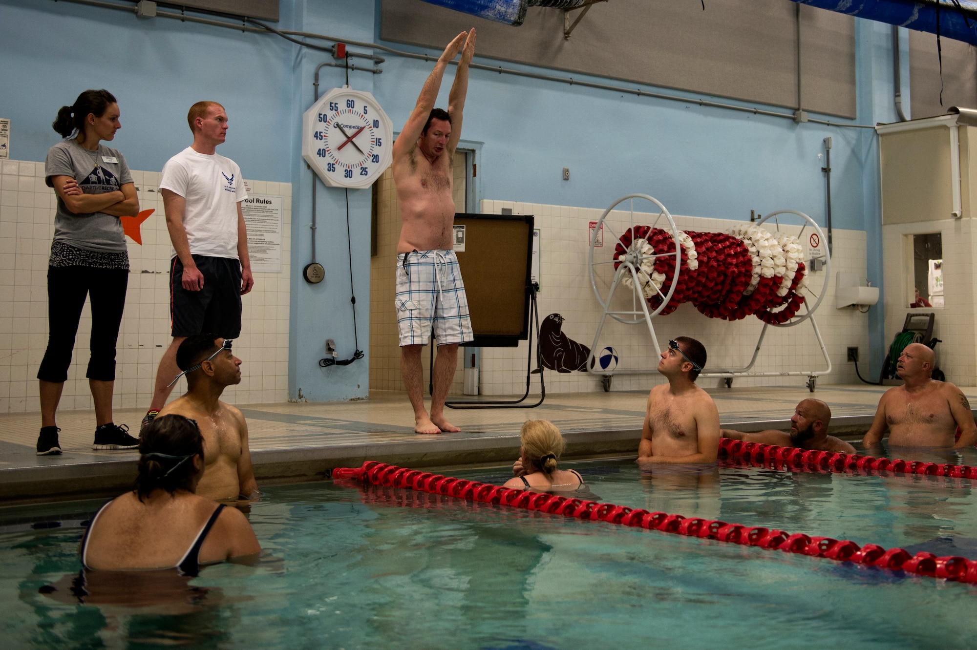 U.S. Air Force Maj. Charlie Toth, Air Force Wounded Warrior (AFW2) Program head swim coach, demonstrates proper streamline technique during the AFW2 Warrior Care event, Aug. 26, 2015 at Joint Base Lewis-McChord, Wash. The Warrior Care event features adaptive and rehabilitative sports activities, career readiness, recovering Airman mentorship and caregiver training. (U.S. Air Force photo by Staff Sgt. Ashley Hyatt)