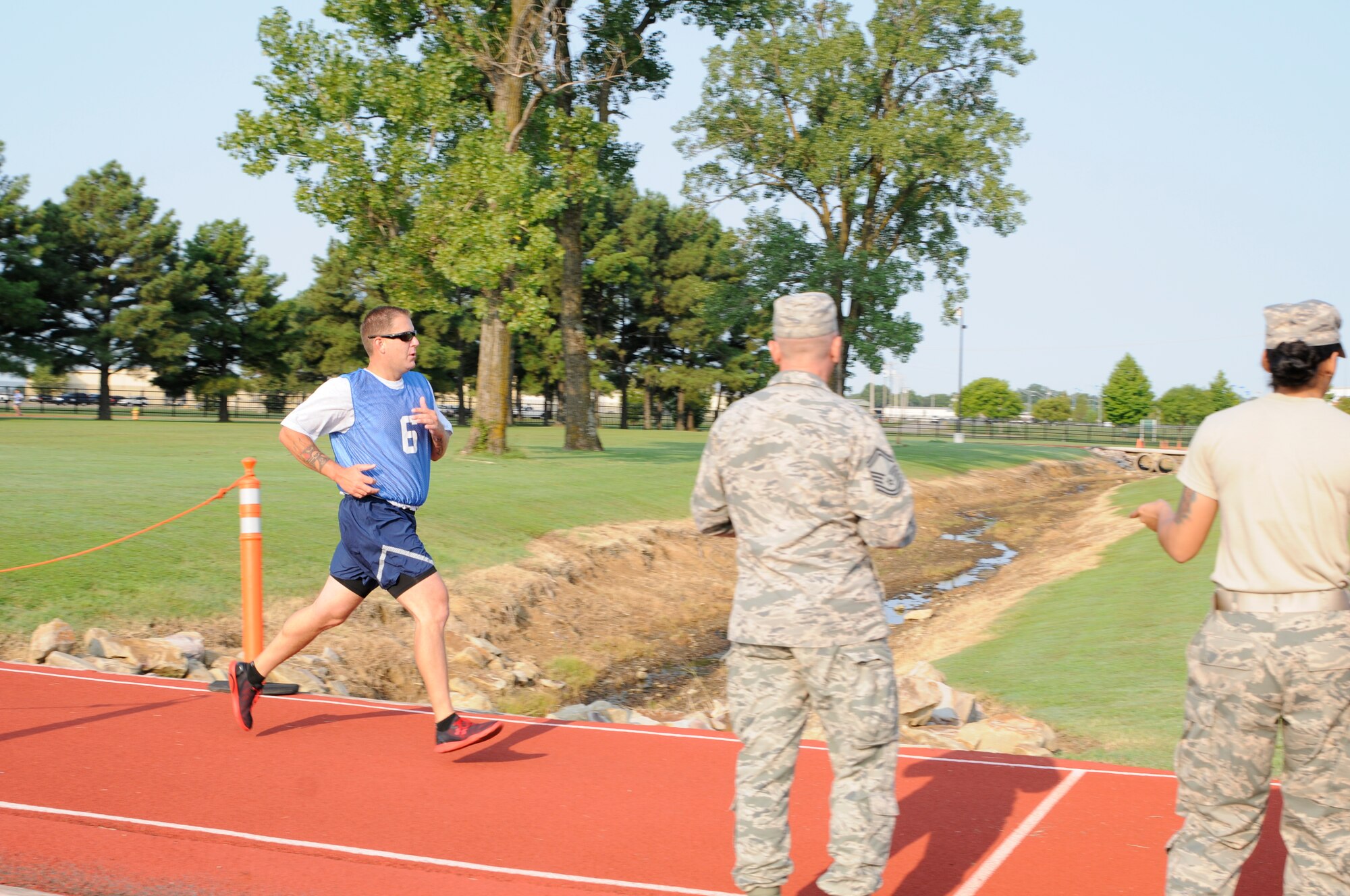Staff Sgt. Preston Carter races to the finish line during his physical fitness test Aug. 26, 2015, at Ebbing Air National Guard Base, Ark. Airmen are always on mission and required to maintain physical fitness to optimize performance and success. The physical fitness test includes a waist measurement, pushups, situps and a 1.5 mile run. Carter is assigned to the 123rd Intelligence Squadron. (U.S. Air National Guard photo by Staff Sgt. Hannah Dickerson/Released)