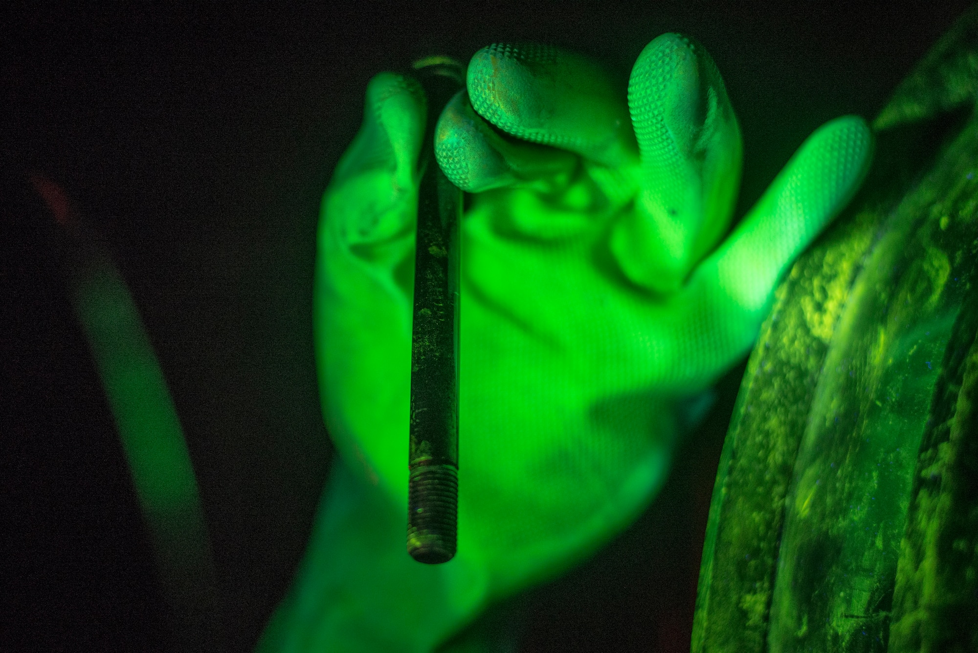 Senior Airman Kayla Hayes, 374th Maintenance Squadron nondestructive inspection technician, performs a magnetic particle test on an aircraft part, Aug. 26, 2015, at Yokota Air Base, Japan. Using a magnetic particle machine, NDI technicians are able to identify cracks that are normally not visible to the naked eye. (U.S. Air Force photo by Airman 1st Class Delano Scott/Released)