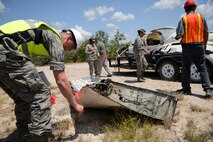 Members of the 47th Civil Engineering Squadron mark debris from a downed aircraft during an exercise in Spofford, Texas, Aug. 26, 2015. All crash site wreckage is considered evidence and is marked, annotated and photographed for investigative purposes. (U.S. Air Force photo by Airman 1st Class Ariel D. Partlow) 