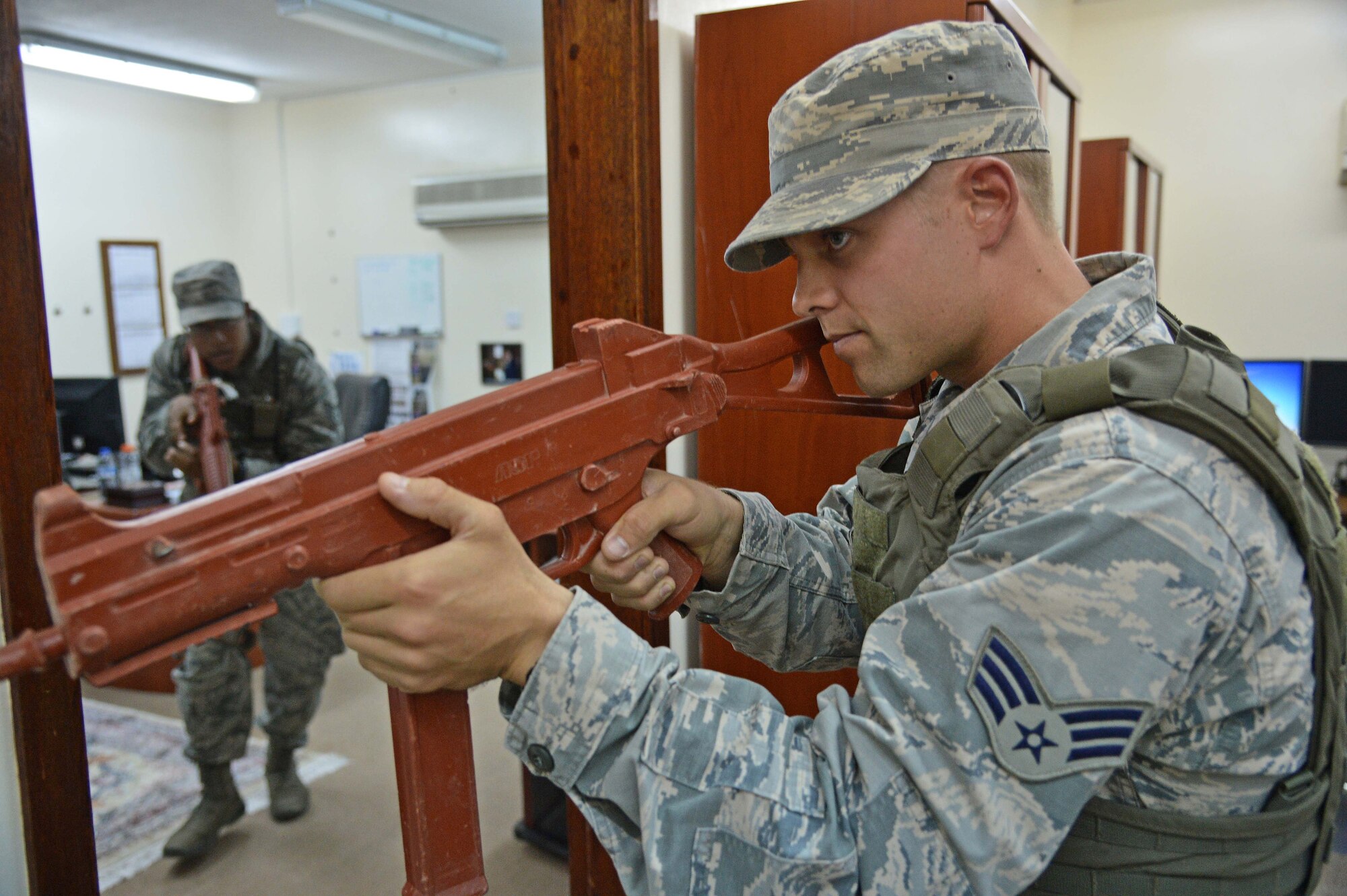 Staff Sgt. William, left, and Senior Airman Evan, 380th Expeditionary Security Forces Squadron response team members, search and clear a building during an active shooter incident response exercise at an undisclosed location in Southwest Asia Aug. 25, 2015. The response was part of a battle drill, which is conducted to train personnel in ‘Check Six’ fundamentals. (U.S. Air Force photo/Tech. Sgt. Jeff Andrejcik) 