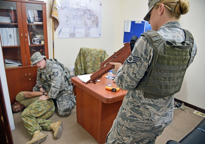 Tech. Sgt. Michael and Staff Sgt. Malissa, 380th Expeditionary Security Forces Squadron response team members, secure the individual playing the role of an aggressor during an active shooter incident response exercise at an undisclosed location in Southwest Asia Aug. 25, 2015. The response was part of a battle drill, which is conducted to train personnel in ‘Check Six’ fundamentals. (U.S. Air Force photo/Tech. Sgt. Jeff Andrejcik)  