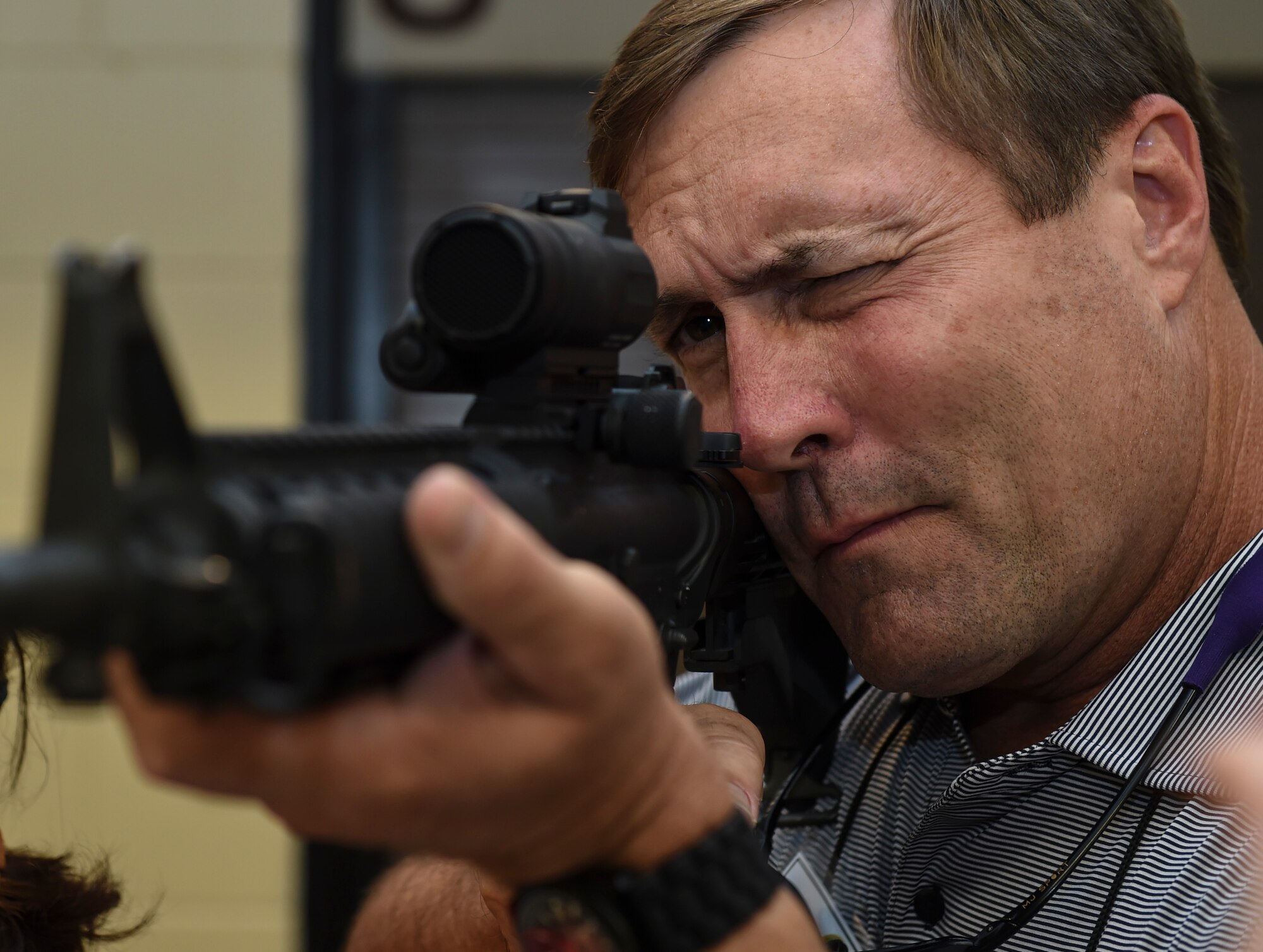 Jeff Compher, East Carolina University athletics director, looks through an M4 Carbine rifle’s sights on Hurlburt Field, Fla., Aug. 26, 2015. More than 20 civic leaders toured Air Force Special Operations Command as part of the Secretary of Defense’s Senior Leader Engagement Program. (U.S. Air Force photo by Airman 1st Class Ryan Conroy)