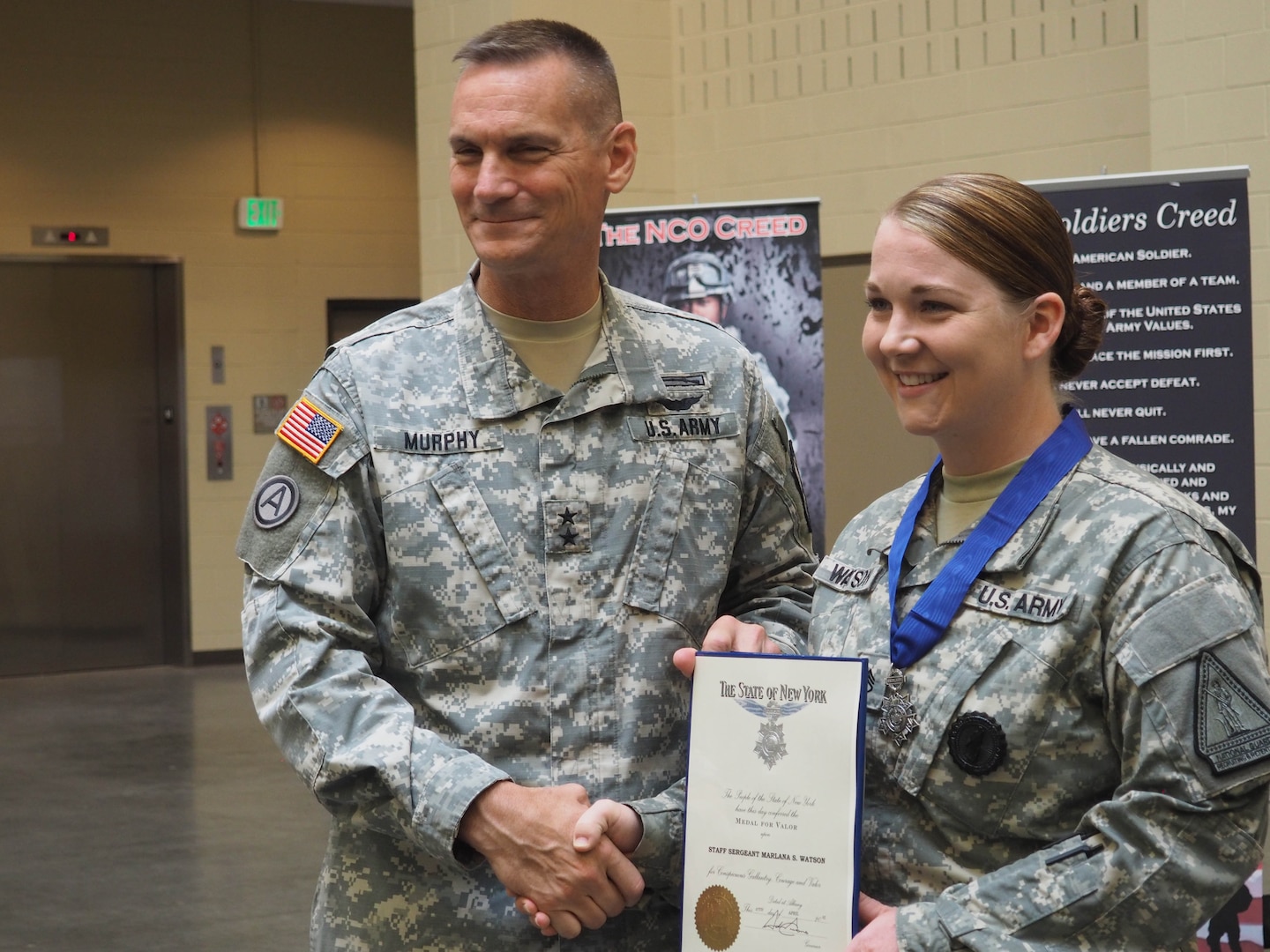 New York Army National Guard Major General Patrick Murphy, the adjutant general of New York, presents the New York State Medal for Valor, the state's highest military award, to Staff Sgt. Marlana Watson, of Lindenhurst, New York, on  Aug. 19, 2015, at the Farmingdale Armed Forces Reserve Center. Watson, a member of the New York Army National Guard's Recruiting and Retention Battalion and a medic, was recognized for rushing across a Syracuse Street on Nov. 5, 2014, to treat two teenagers injured in a drive-by shooting, without regard for her own safety, since the shooter may have still been in the area. 