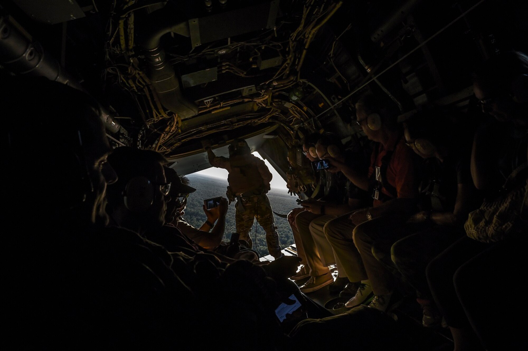 National civic leaders take video of an aerial gunner during a CV-22 Osprey flight at Hurlburt Field, Fla., Aug. 26, 2015. Peter Marx, City of Los Angeles chief technology officer, said the whole experience was humbling. “I never thought I would have the opportunity to be this close to military action,” he said on board the aircraft, referring to the pararescueman seated next to him. (U.S. Air Force photo by Airman 1st Class Ryan Conroy)